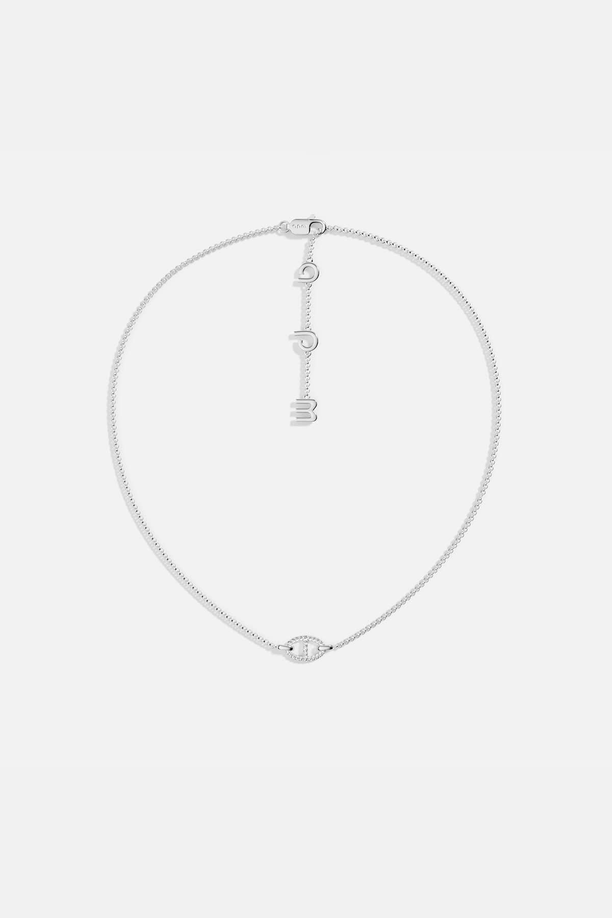 Necklaces APM Monaco, white tone, maille marine chain with a pendant of three hanging letters.