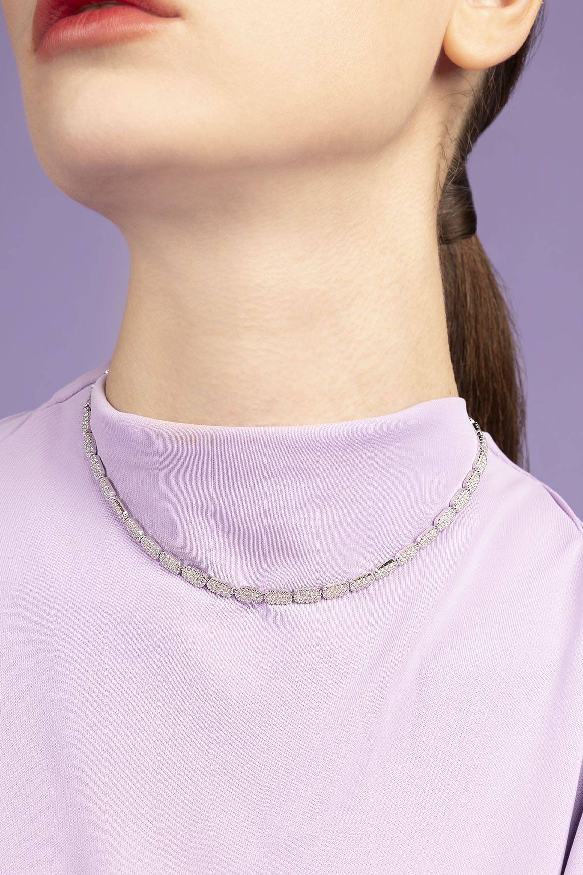APM MONACO dainty adjustable necklace worn by model on purple background