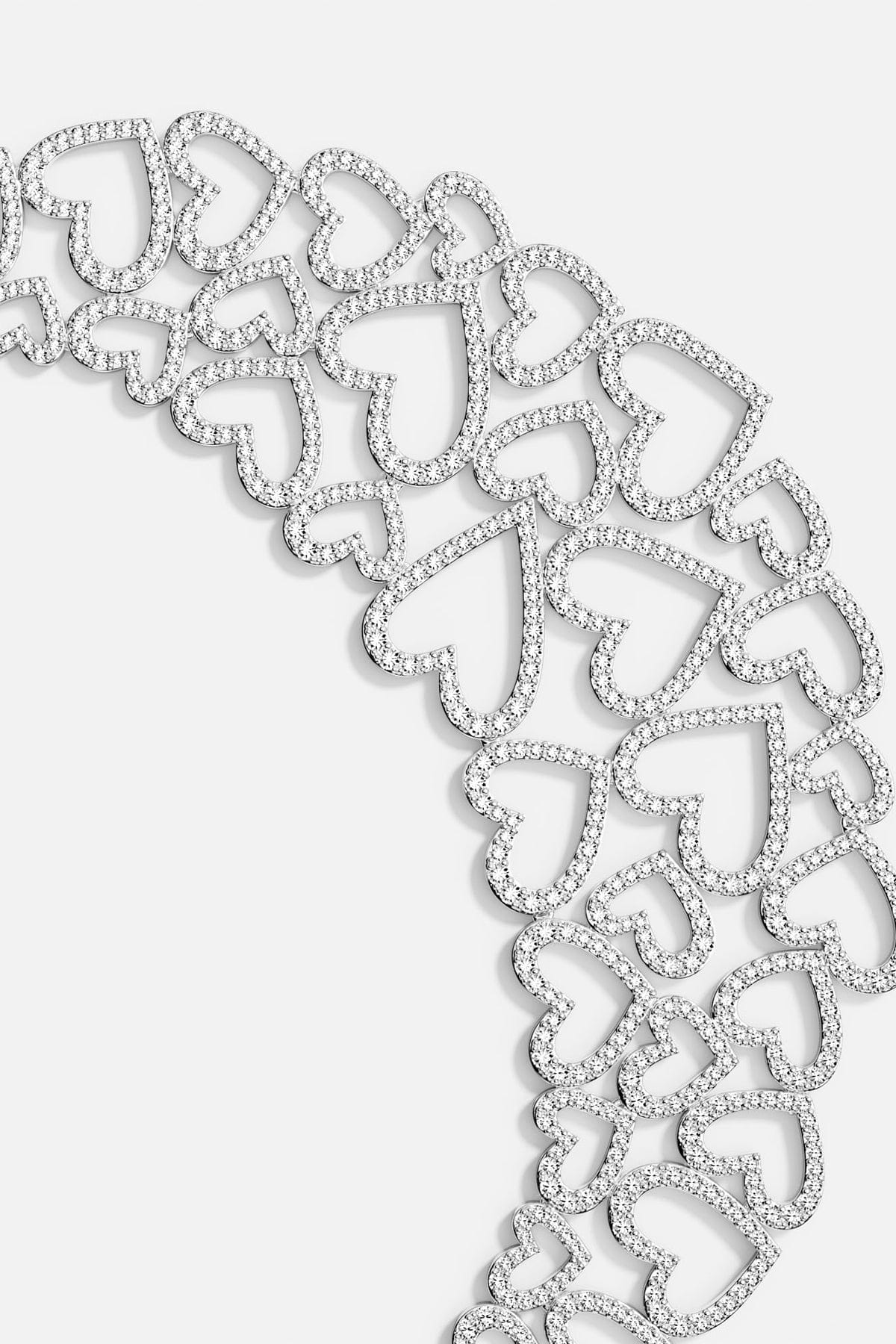 APM MONACO silver necklace with heart-shaped pendants on a white background