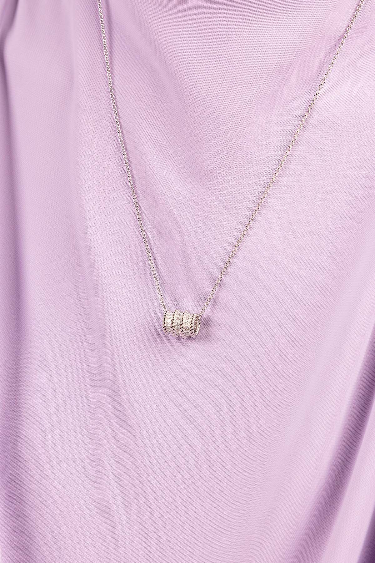 APM MONACO torsade adjustable necklace in silver worn on model with purple shirt