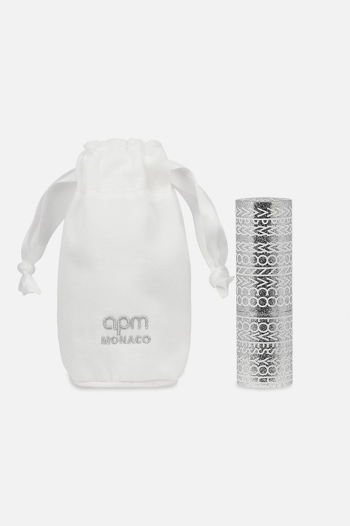 White pouch with 'apm monaco' branding next to a silver patterned lip balm on a white background