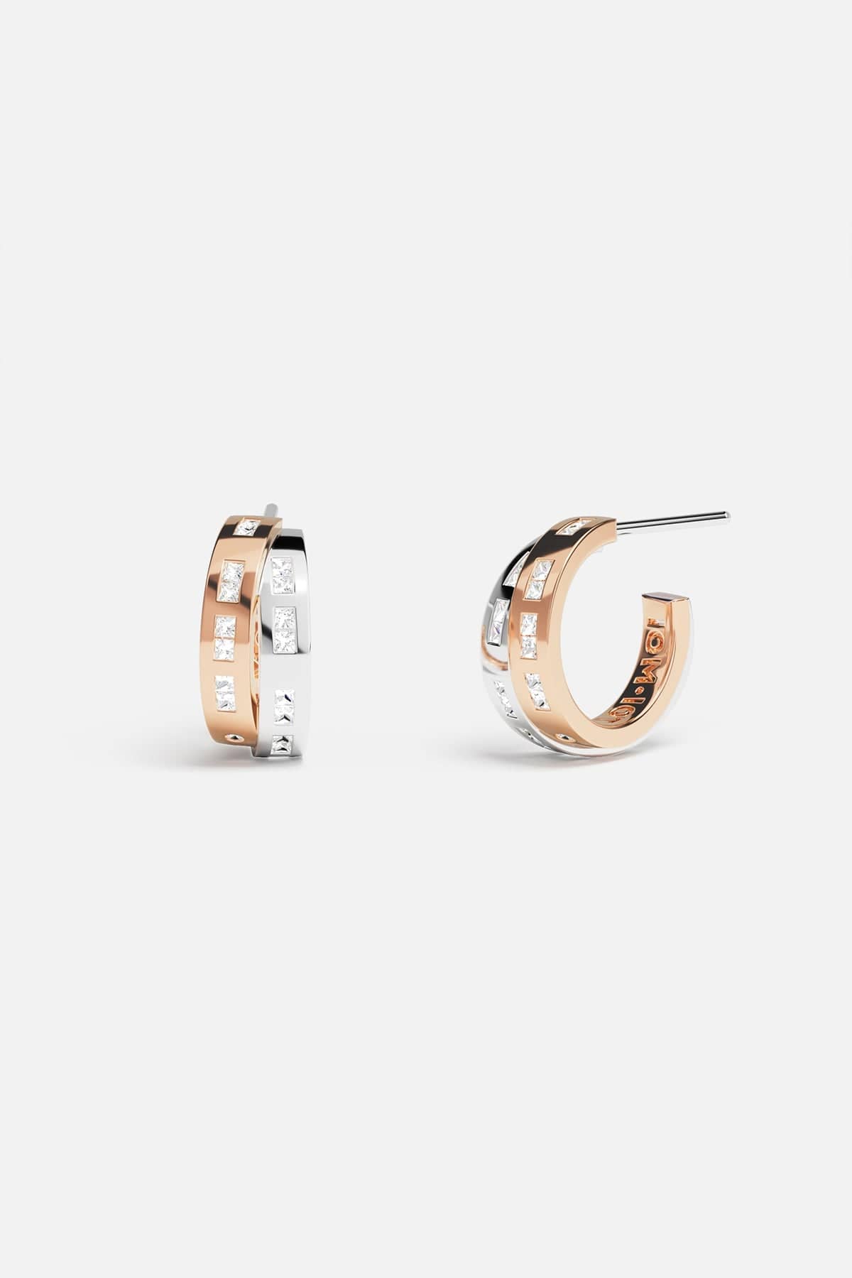Earrings APM Monaco: two-tone rose gold and white gold intertwined design with morse-code motif, minimalist and delicate.