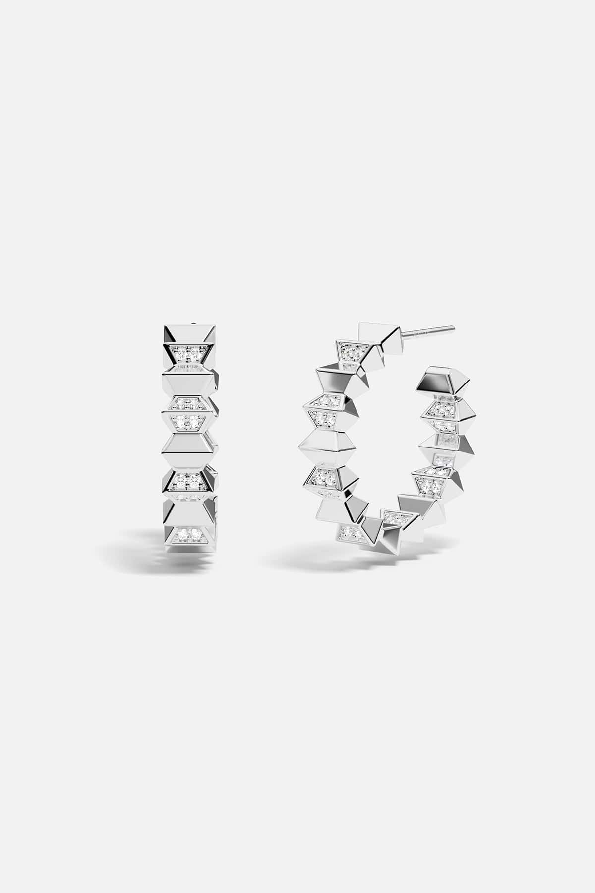 Pair of silver hoop earrings with geometric design on a white background