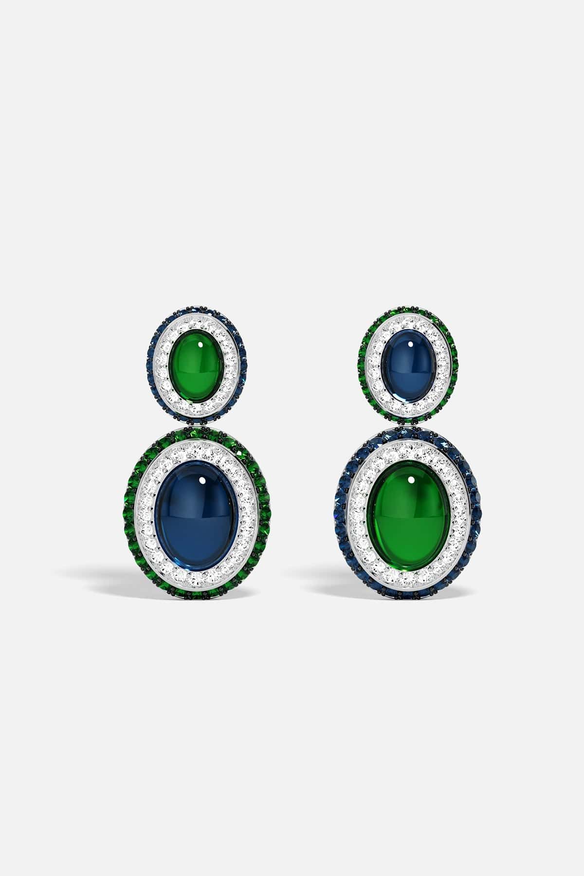 Pair of earrings with green and blue stones on a white background