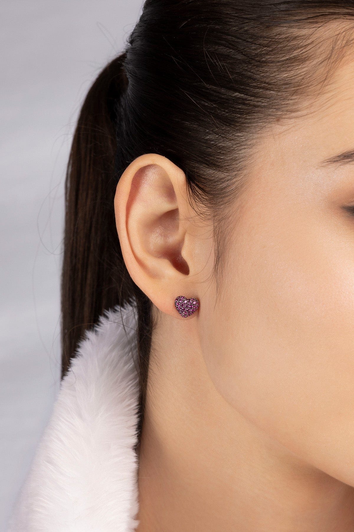 APM MOACO fuchsia heart stud earrings in silver worn on model