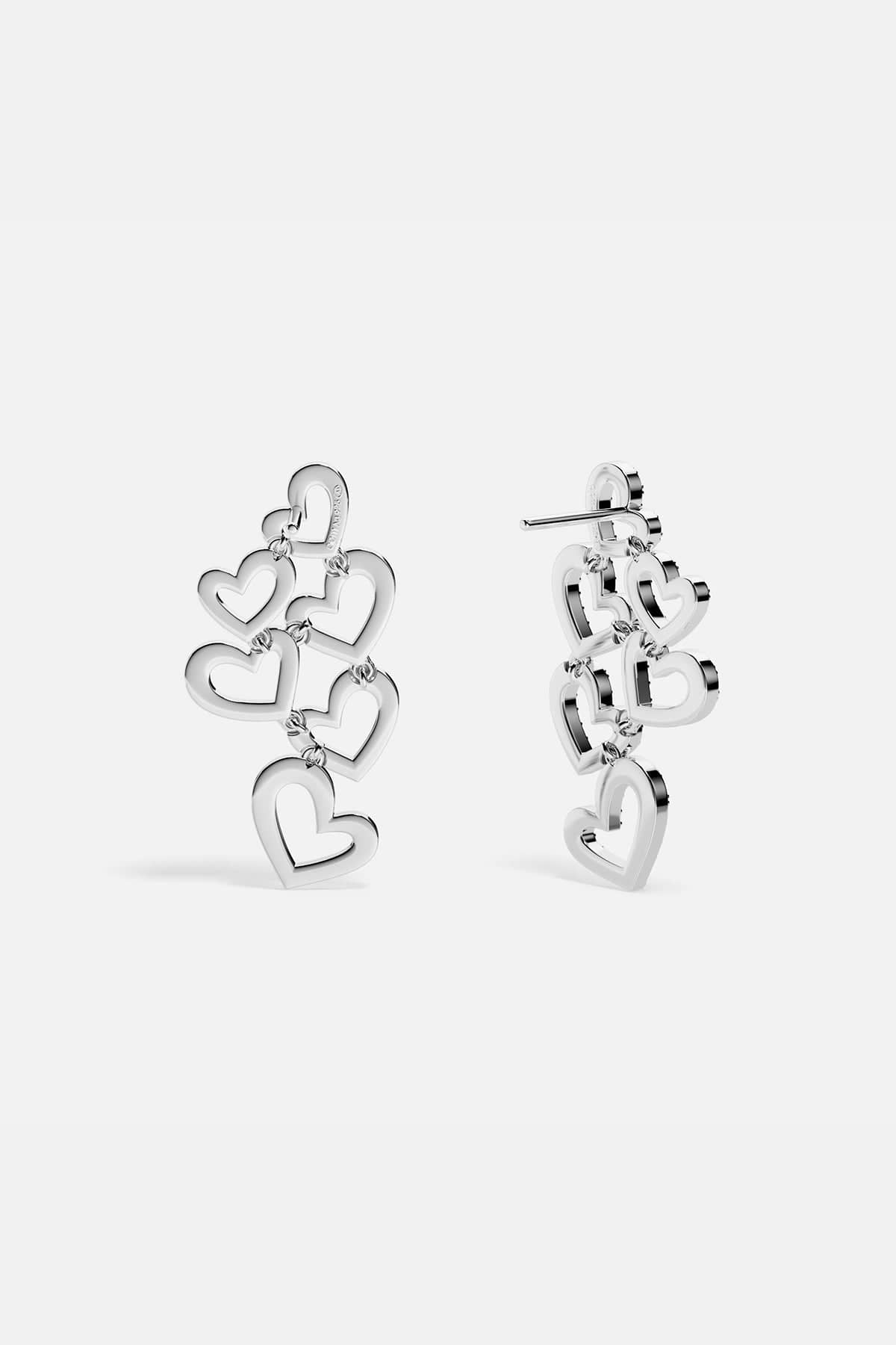APM MONACO heart-shaped earrings in silver on a white background