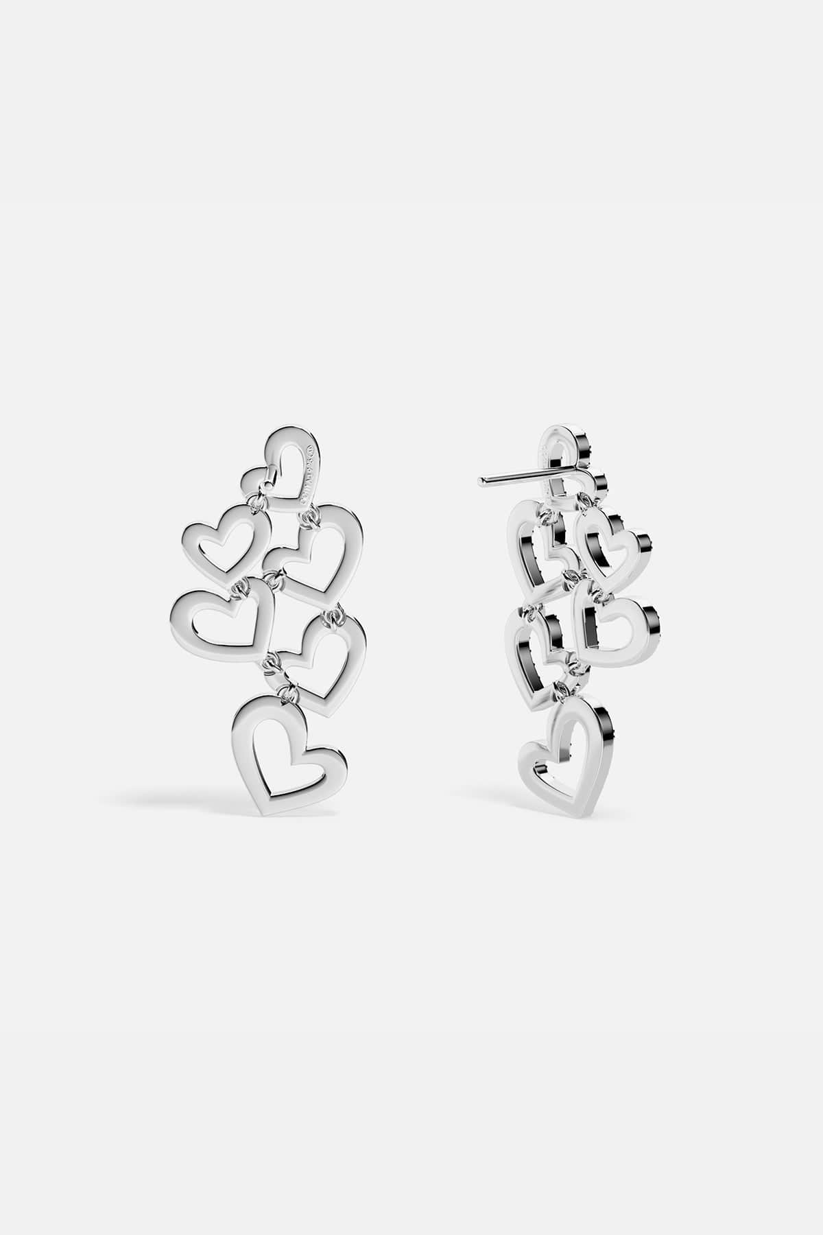 APM MONACO heart-shaped earrings in silver on a white background