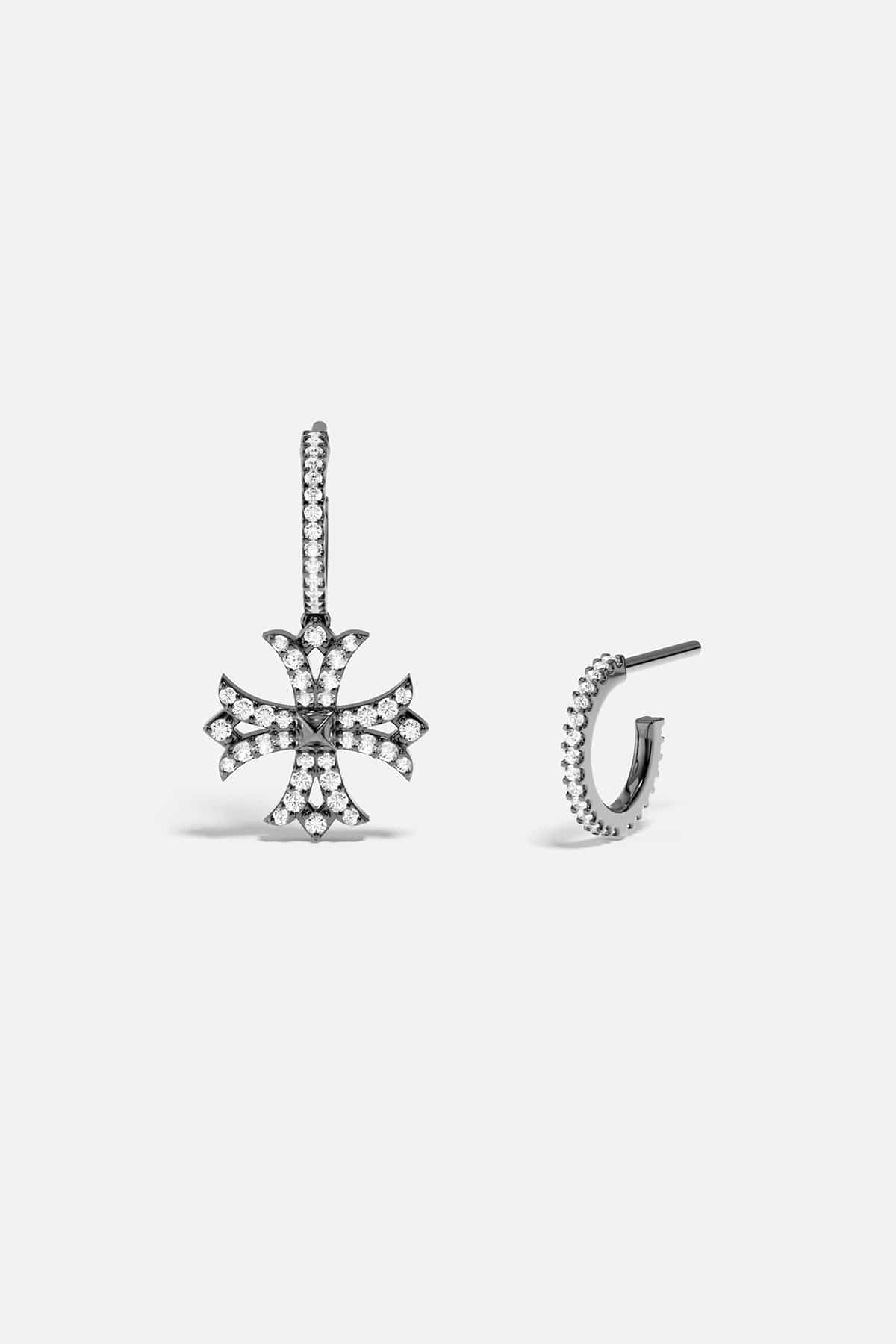 Silver earring with cross design on a white background