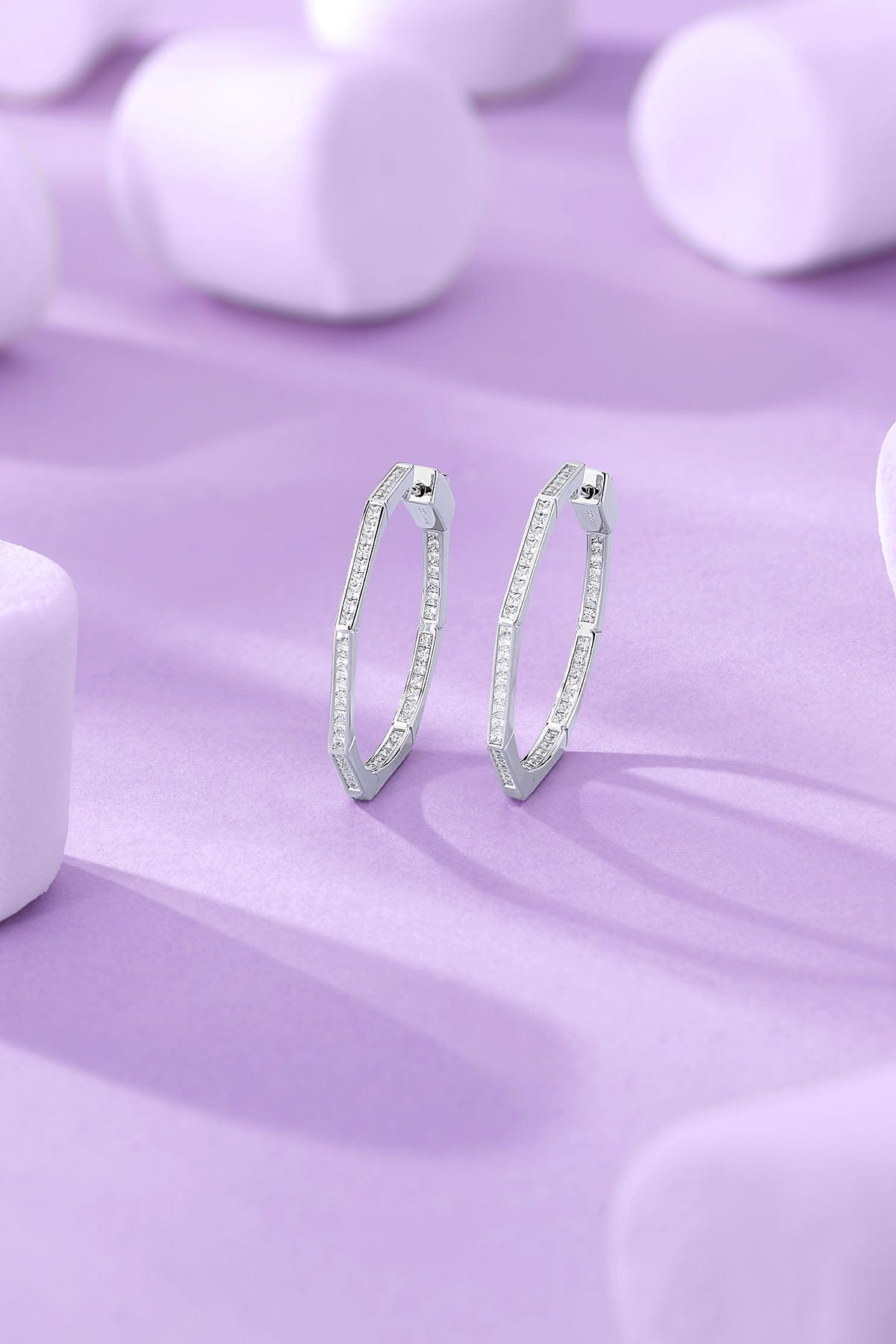 Geometric Hoop Earrings on a purple background