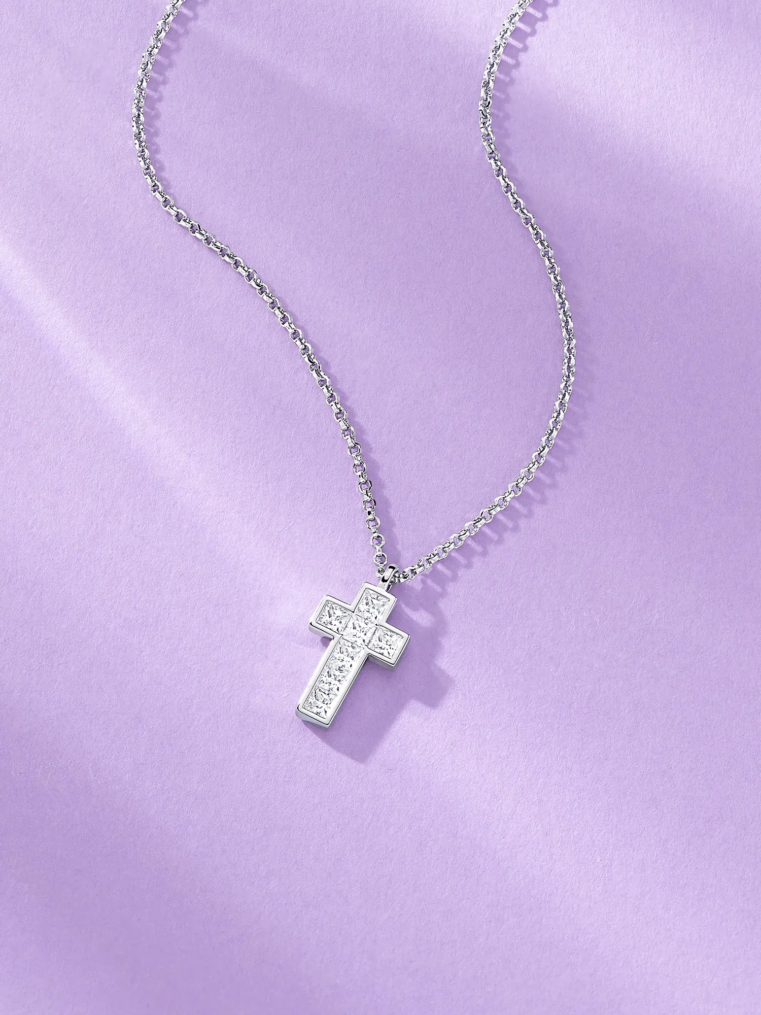 APM Monaco Cross Necklace on Lilac Background