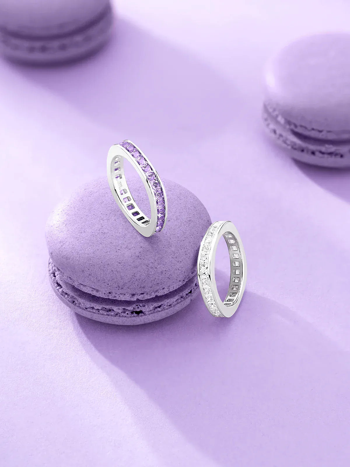 APM Monaco Silver rings on purple macaron cookies with a light purple background