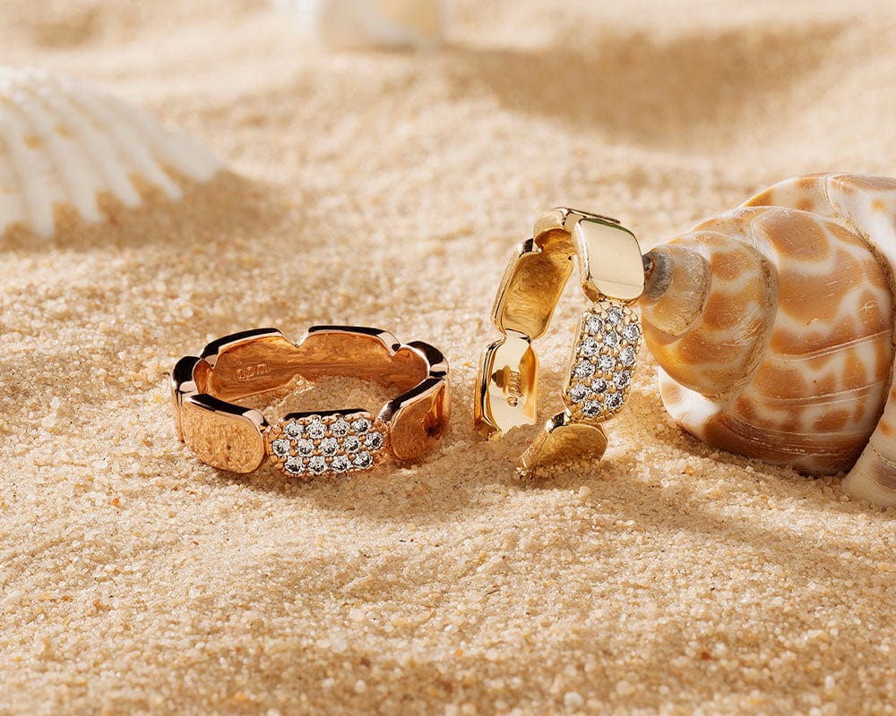 APM Monaco Yacht Club Dainty Rings on sand background