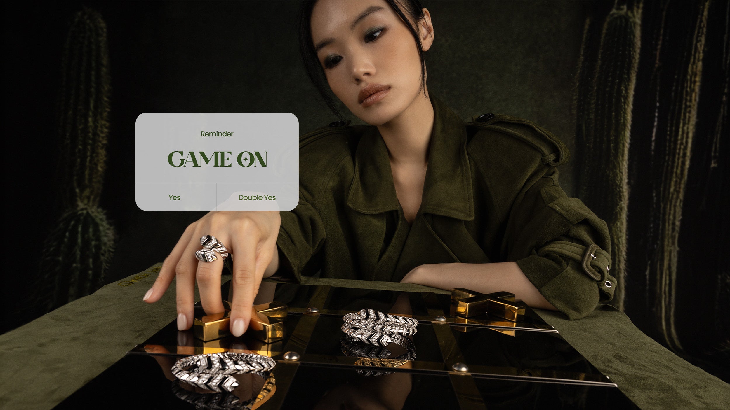 Woman holding apm monaco jewelry with a 'Game On' card in the background