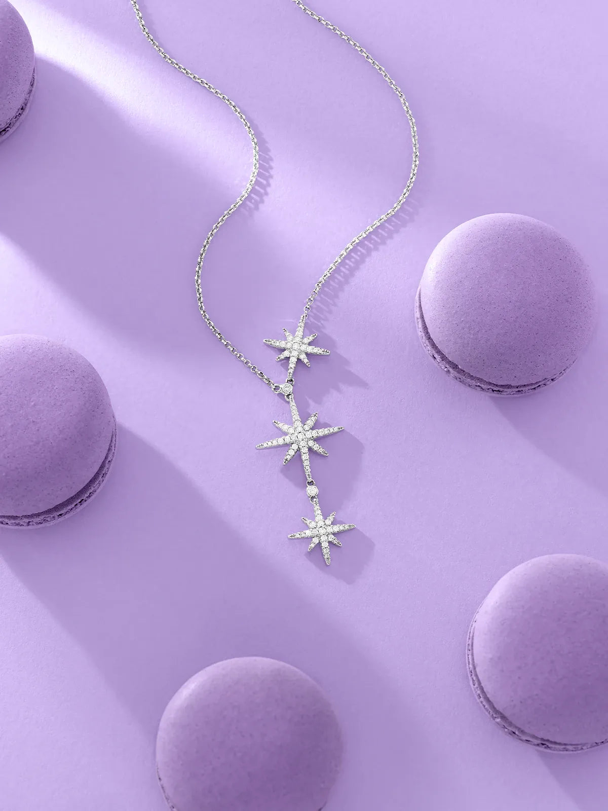 APM Monaco meteorites necklace on a purple surface with macarons