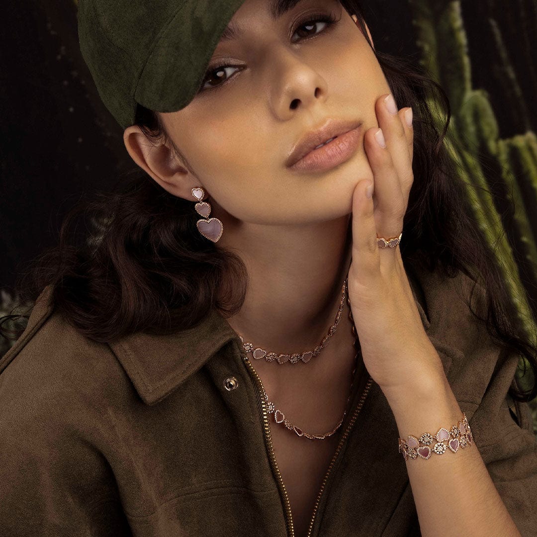 Woman wearing jewelry with a cactus in the background