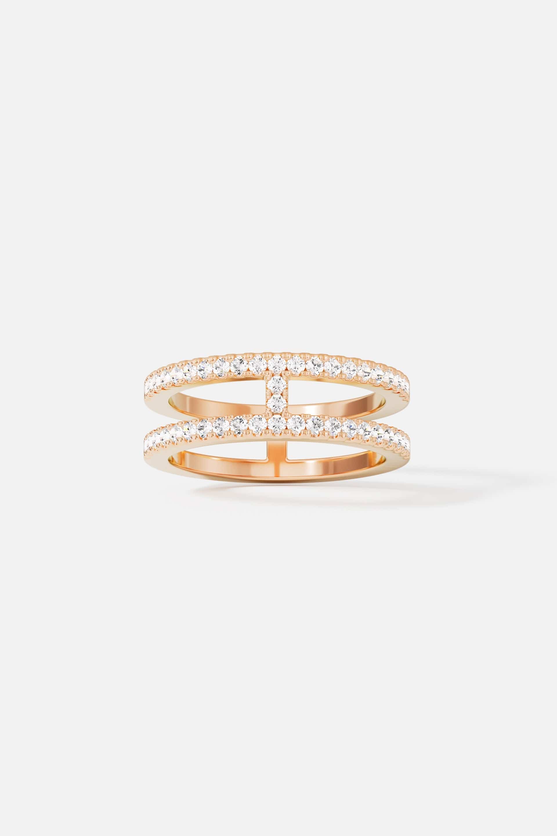 Rings APM Monaco. Double-line pavé ring featuring two parallel bands connected in the middle with pavé crystals, creating a sparkling, contemporary silhouette.