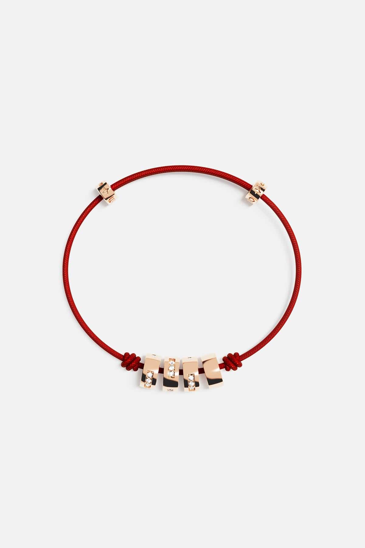 Bracelets APM Monaco red thread morse-code string bracelet with gold-tone charms.