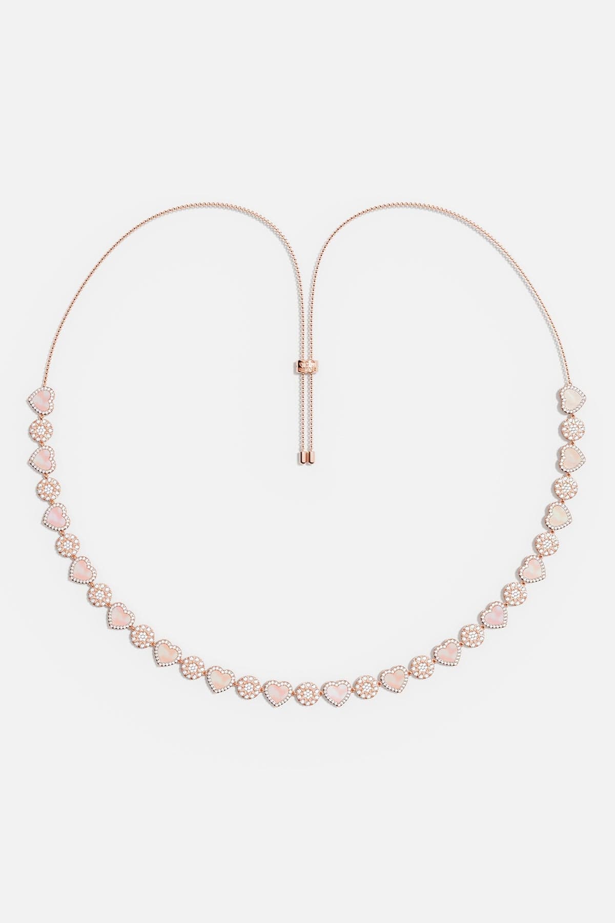 Necklaces APM Monaco. Rose gold tone adjustable necklace with pink nacre heart pendants, separated by small clear stones.