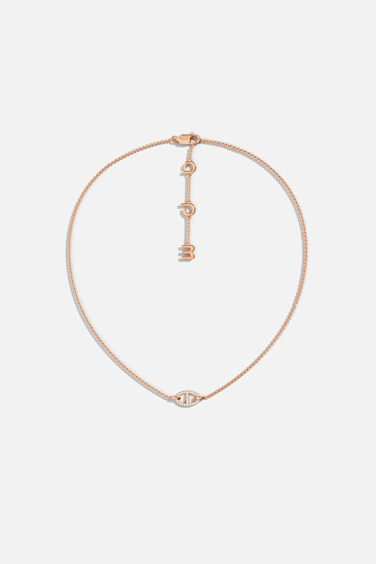 APM MONACO rose gold necklace with unique pendant on a white background