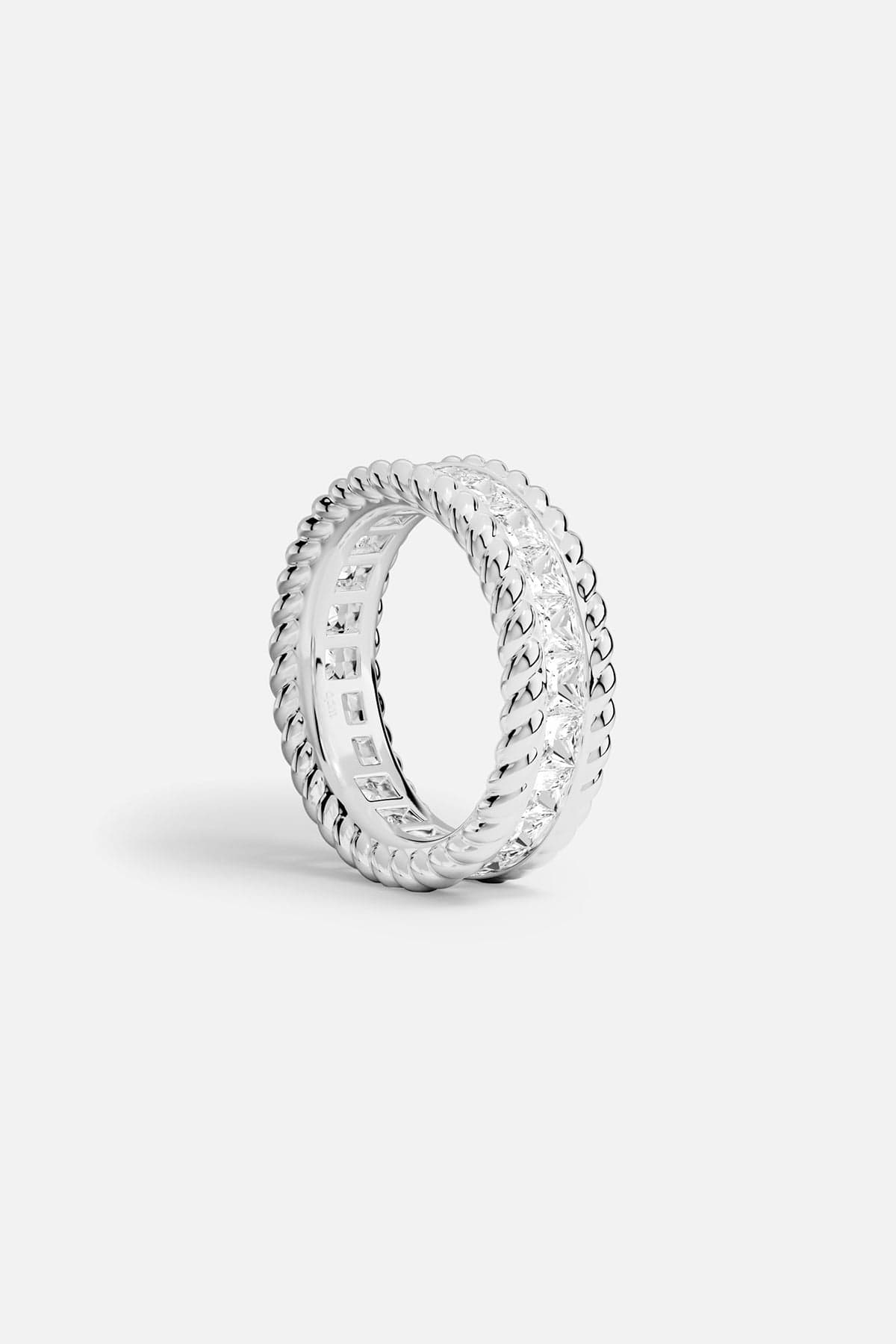 Alloy ring with a torsade design on a white background