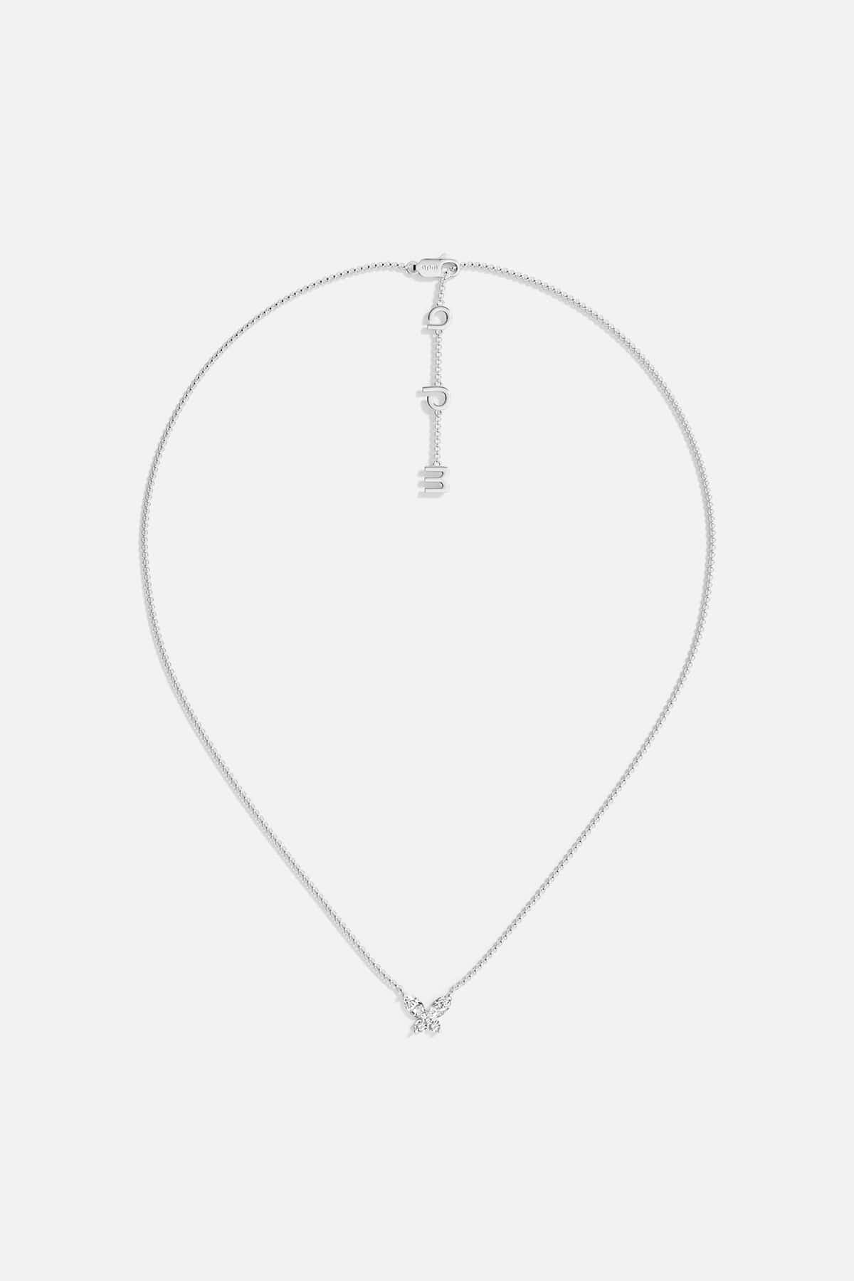 Necklaces APM Monaco. White gold butterfly necklace with white cubic zirconia on a Silver-tone chain; butterfly pendant and APM clasp.