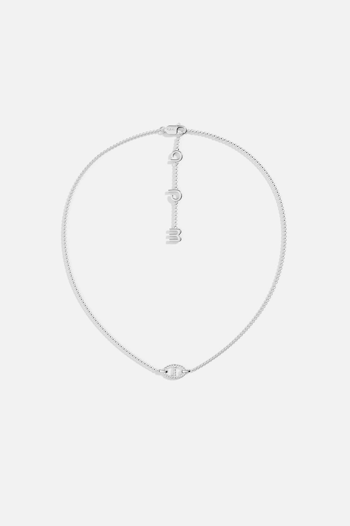 Necklaces APM Monaco, white tone, maille marine chain with a pendant of three hanging letters.