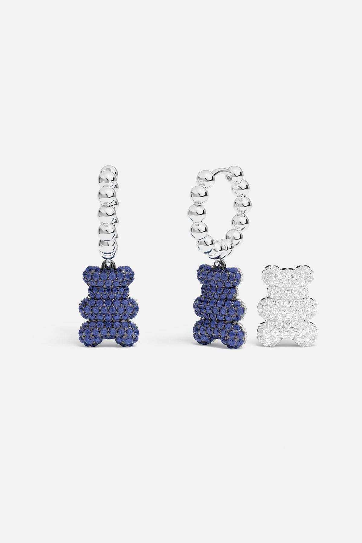 Earrings APM Monaco, silver-tone hoop earrings with a bead chain and bear charms; bears encrusted with Blue/White cubic zirconia.