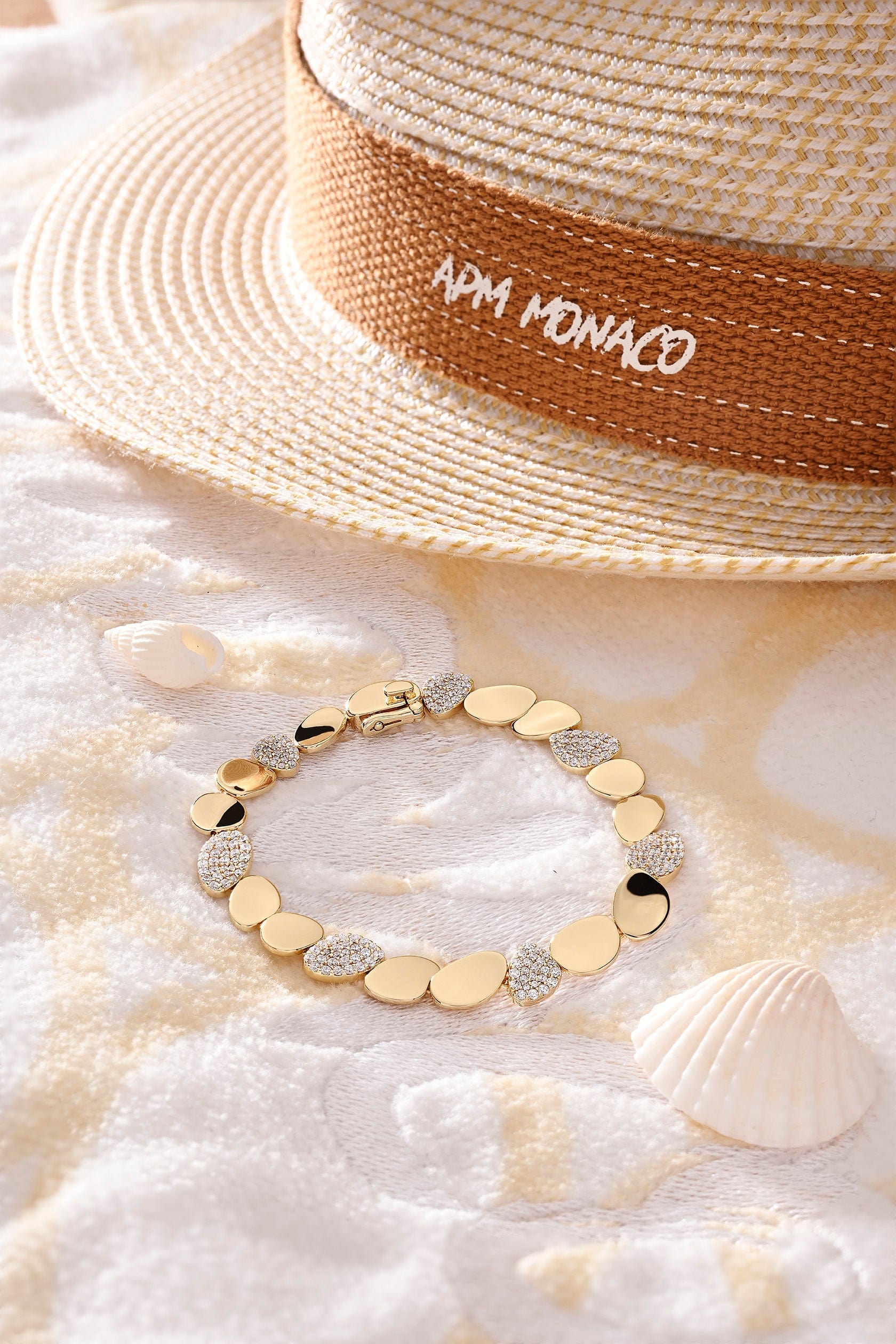 APM Monaco Galet Bracelet in Yellow Gold on soft blanket