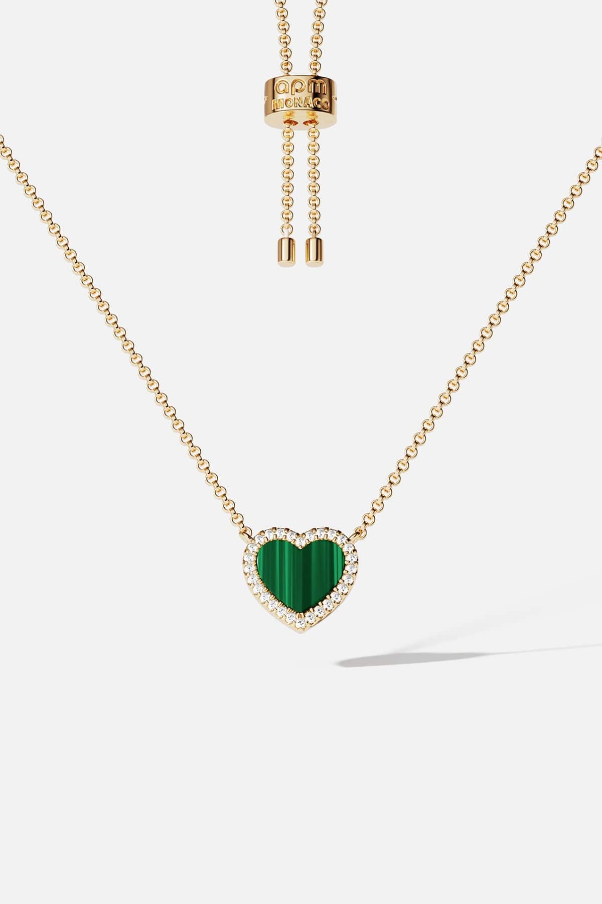 Necklaces APM Monaco. Yellow-gold chain with a green malachite heart pendant surrounded by white stones; adjustable length.
