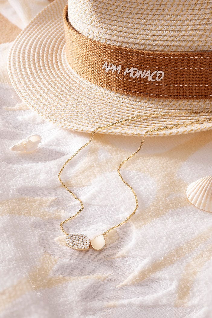 APM Monaco Galet Adjustable Necklace in yellow gold and on a soft blanket