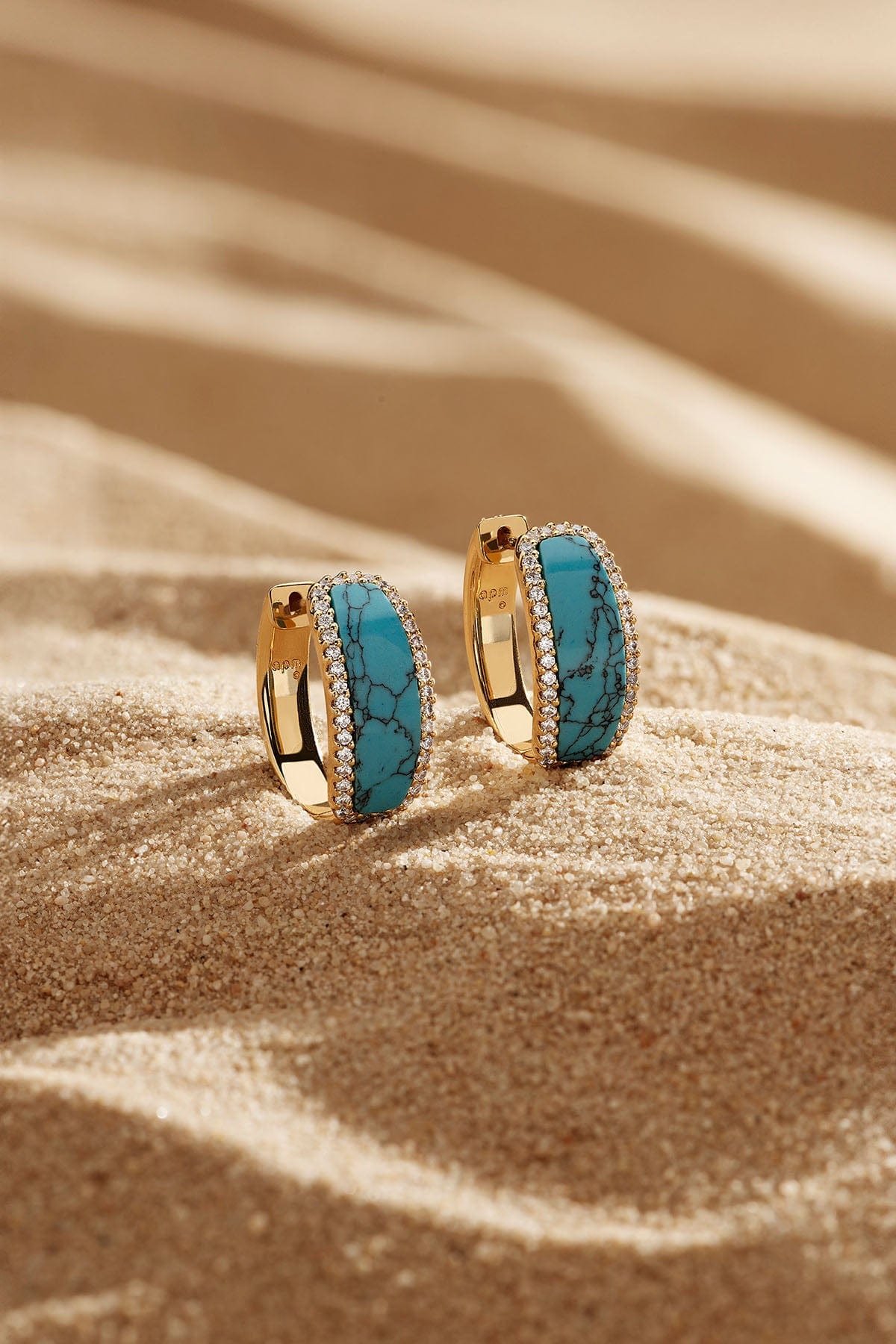 APM Monaco Lagoon Hoop Earrings in Yellow Gold on soft beach
