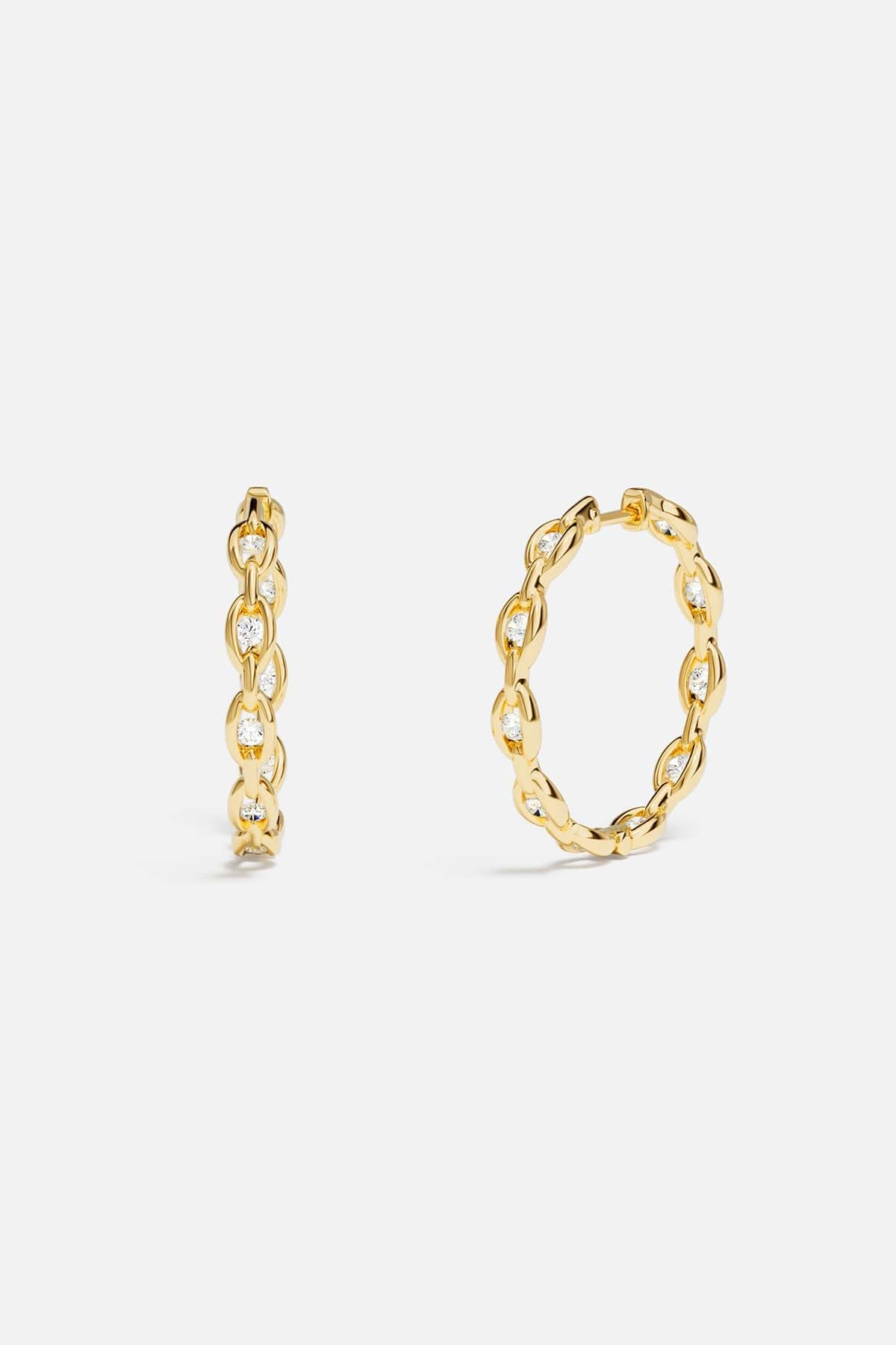 Earrings APM Monaco: yellow-gold pavé chain hoops with white diamonds.