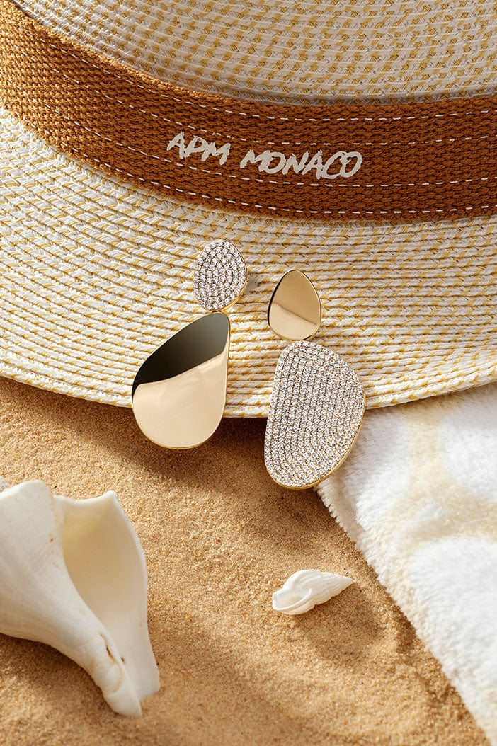 APM Monaco Galet Earrings in Yellow Gold on warm beach