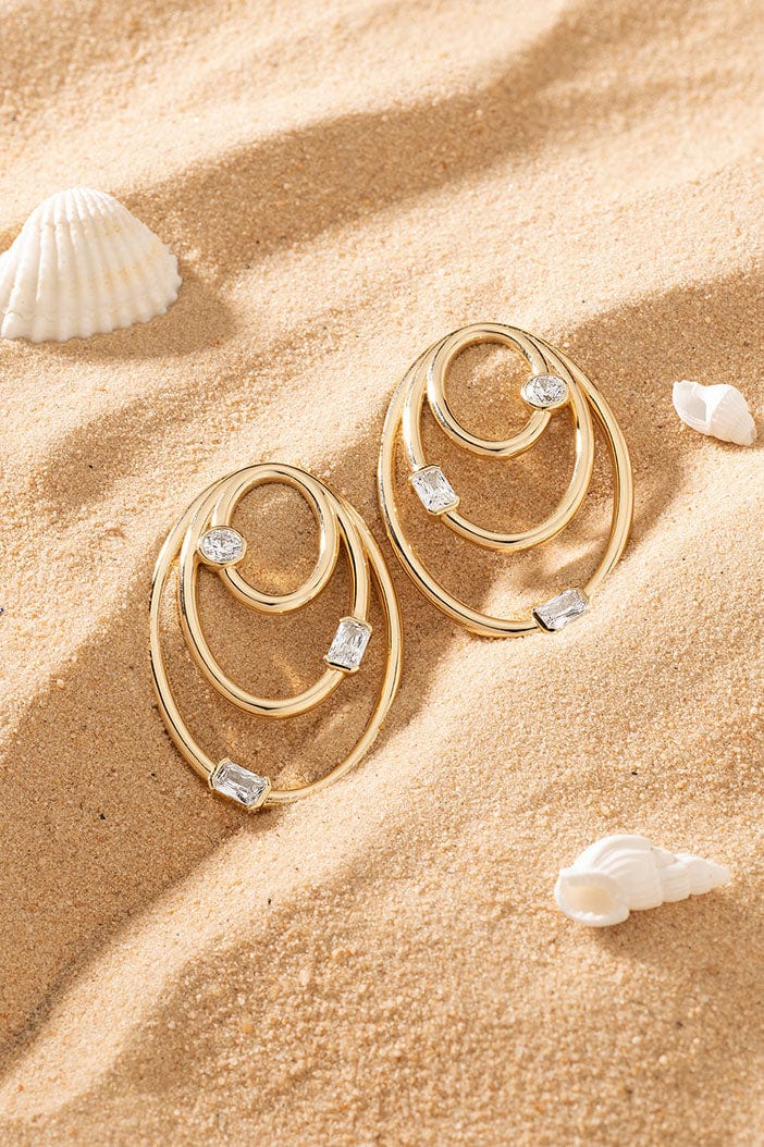 APM Monaco Triple Éclat Earrings in Yellow Gold on soft beach