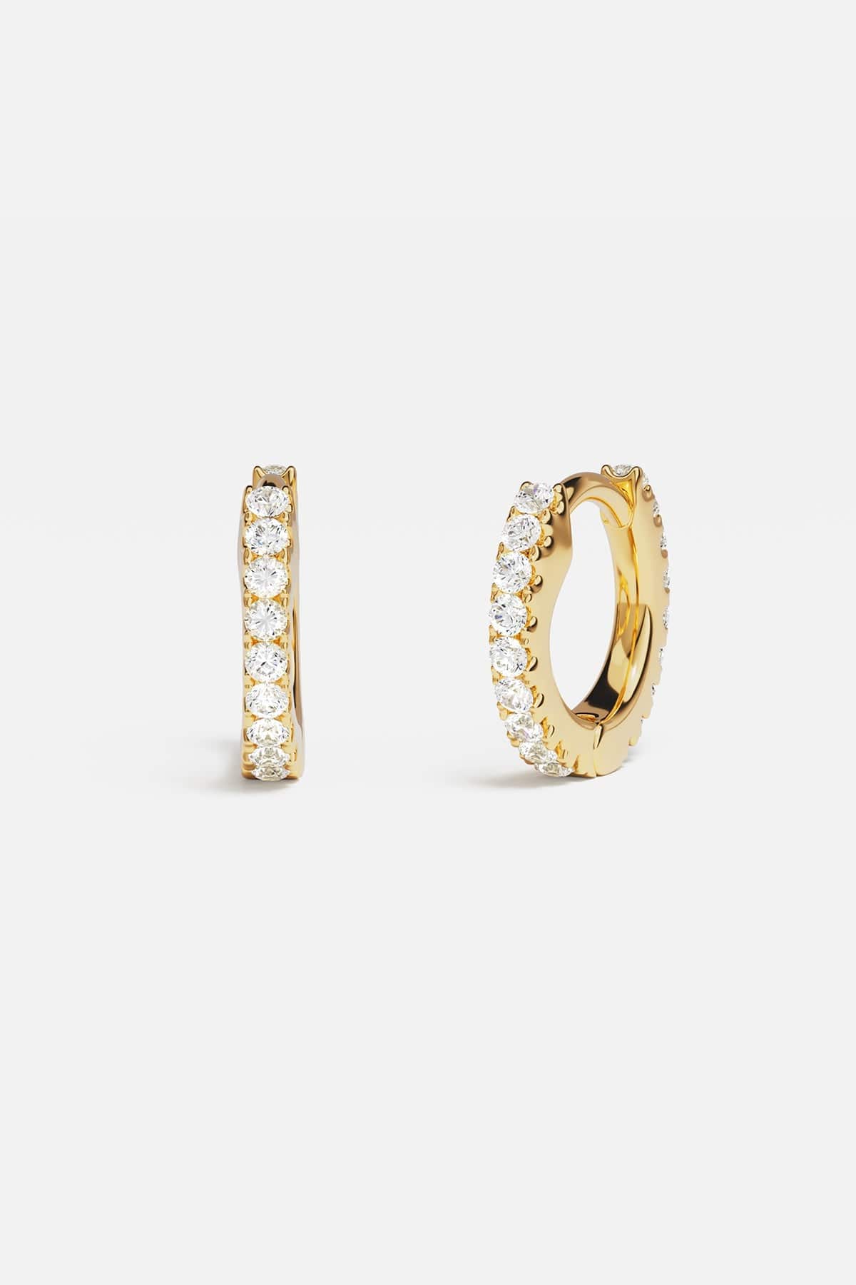 Earrings APM Monaco: yellow gold huggie hoops with white diamonds.