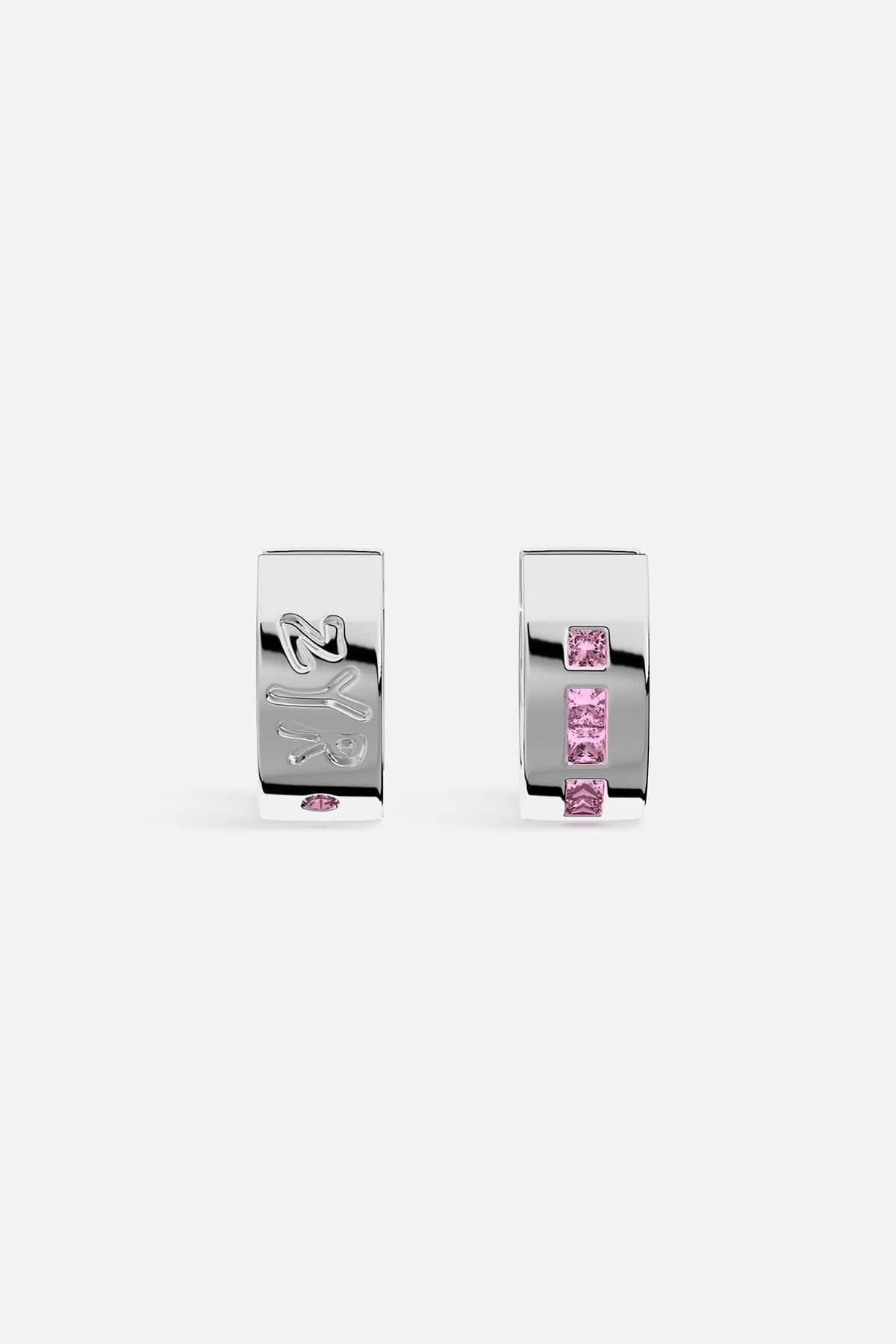 Silver hoop earrings with pink gemstones on a white background
