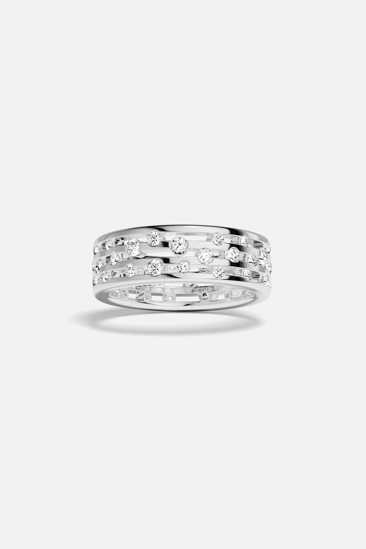 APM Ring in rhodium finish, scattered sparkles across open bands, effortlessly modern.