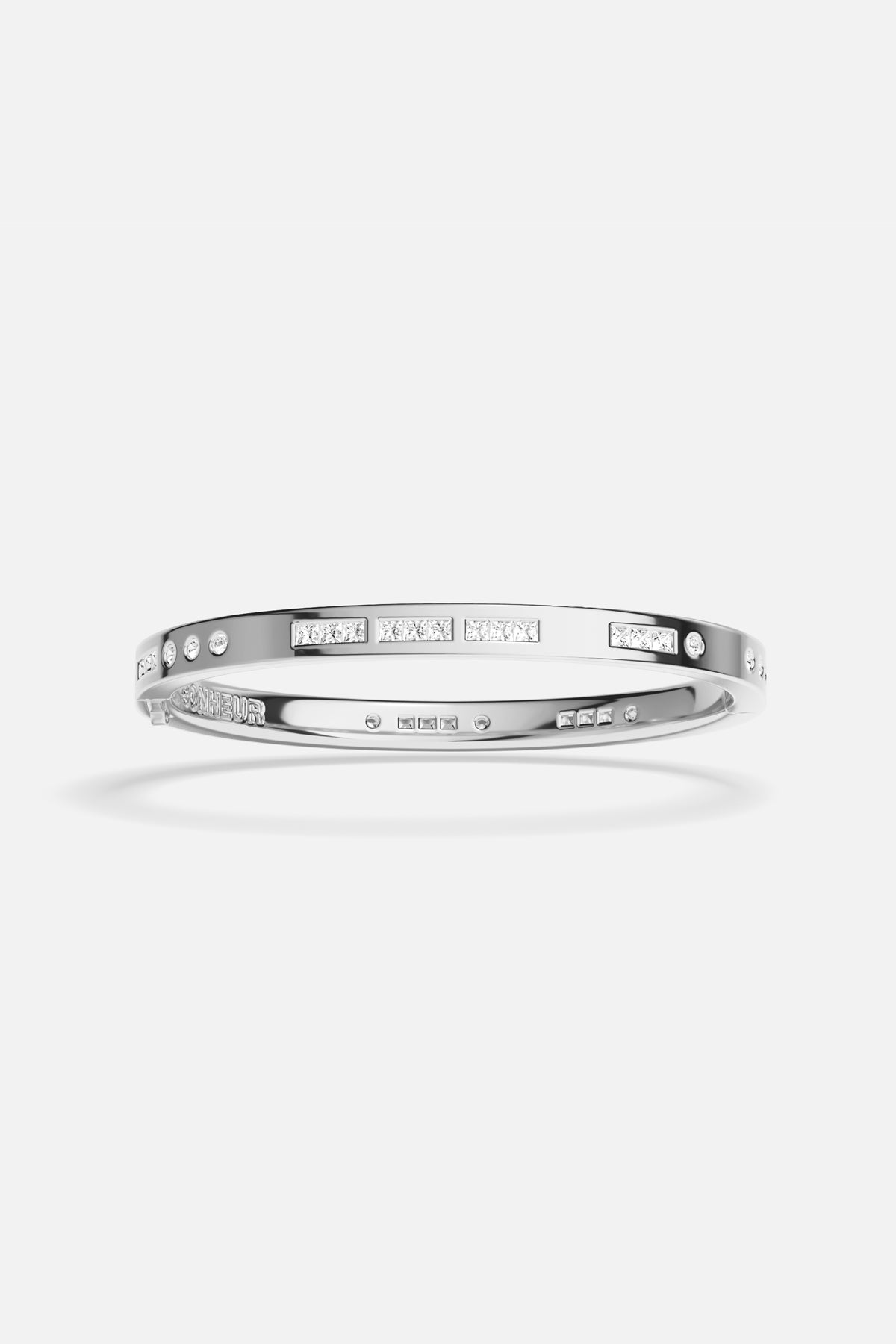 APM Bangle in rhodium finish, a sleek statement of modern elegance.