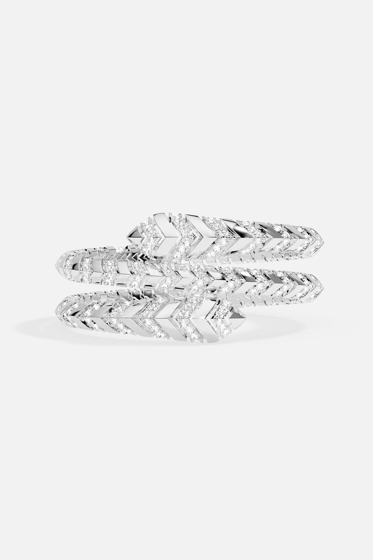 APM Bracelet coiling in rhodium finish, a sleek chevron shimmer wrapped with quiet confidence.
