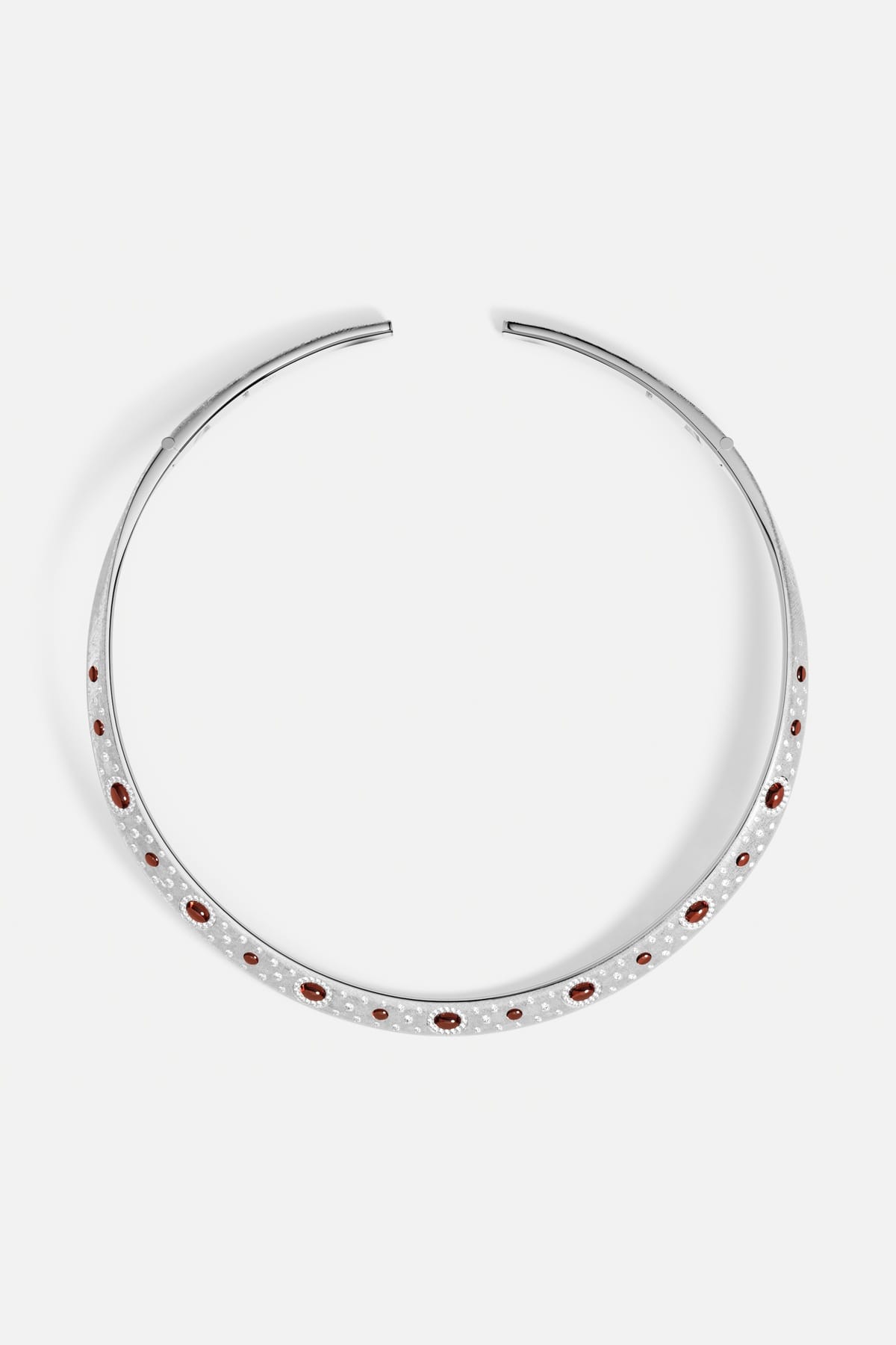 APM open collar necklace in rhodium finish, glowing with deep red accents.