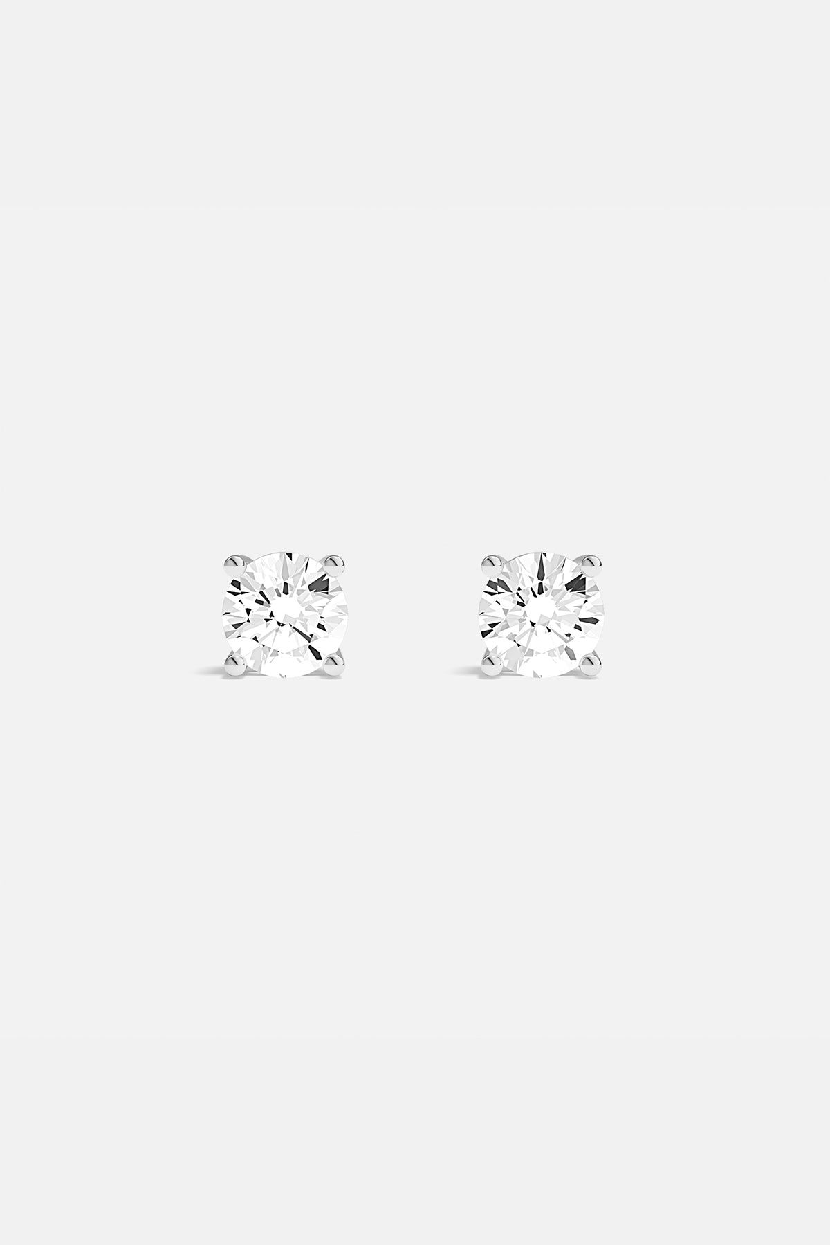 APM Stud Earrings, timeless brilliance in a rhodium finish, effortlessly radiant.
