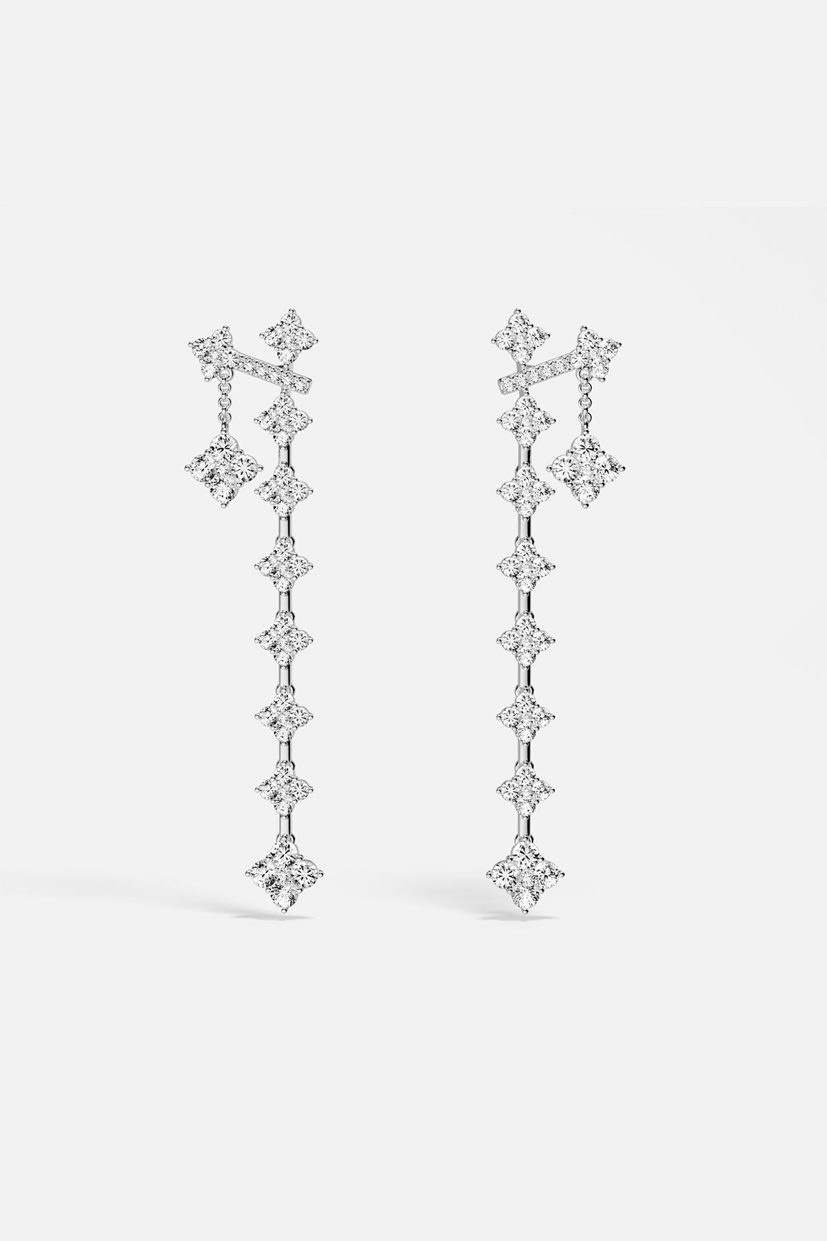 APM Drop Earrings cascading in luminous rhodium finish, effortlessly radiant.