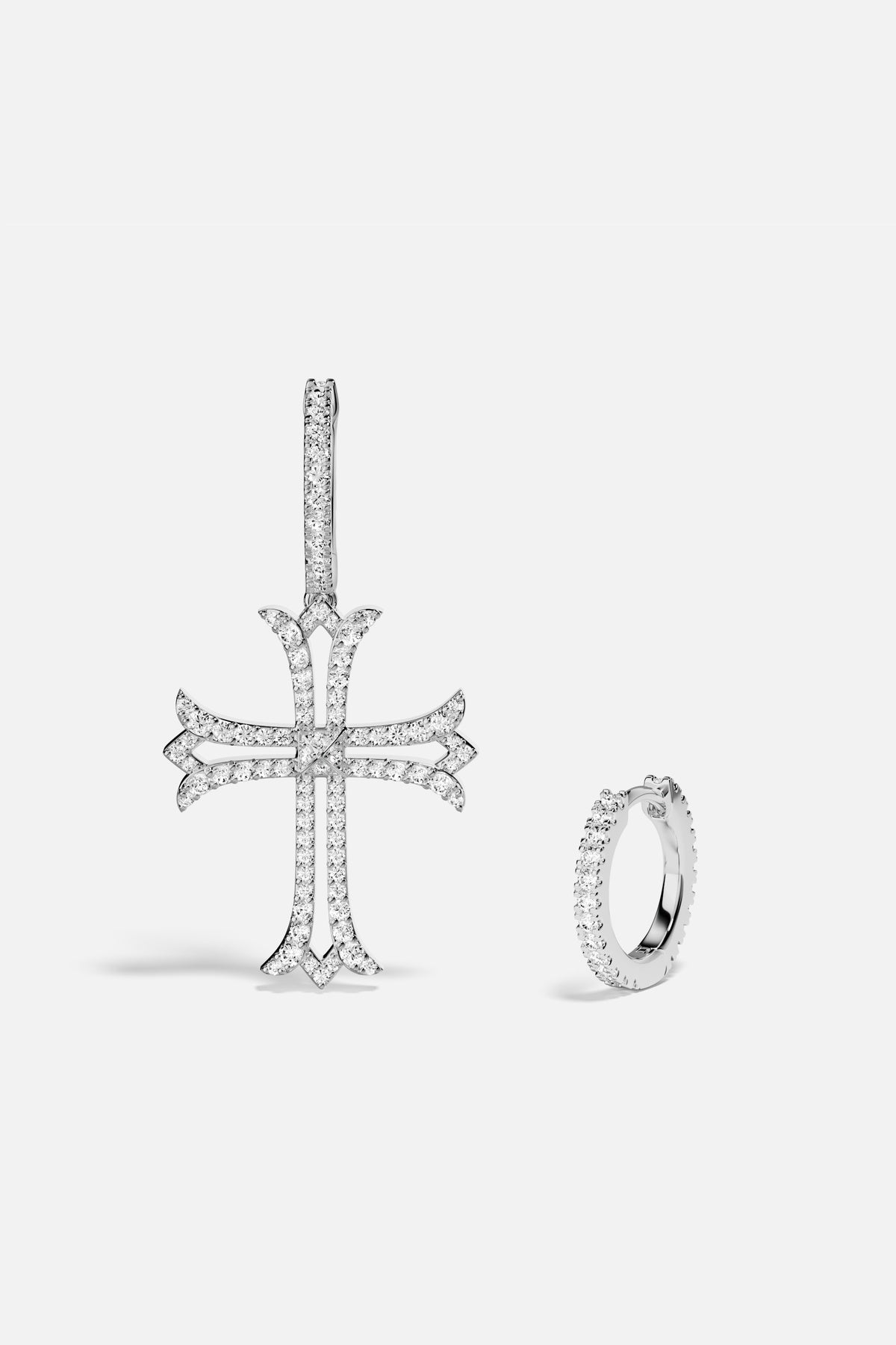 APM Cross Earrings, a bold asymmetry shimmering with rhodium finish allure.