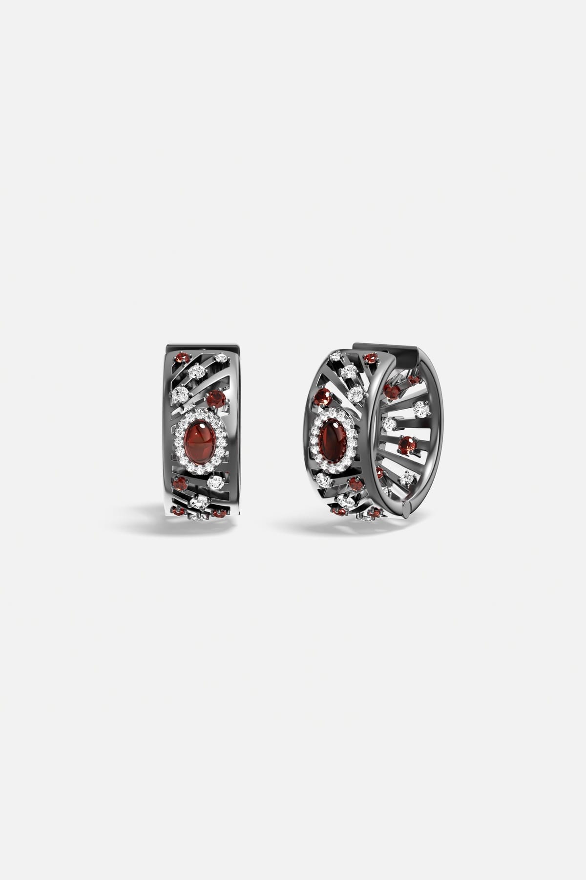APM Monaco hoop earrings, deep red glow within a smoky rhodium finish, quietly bold.