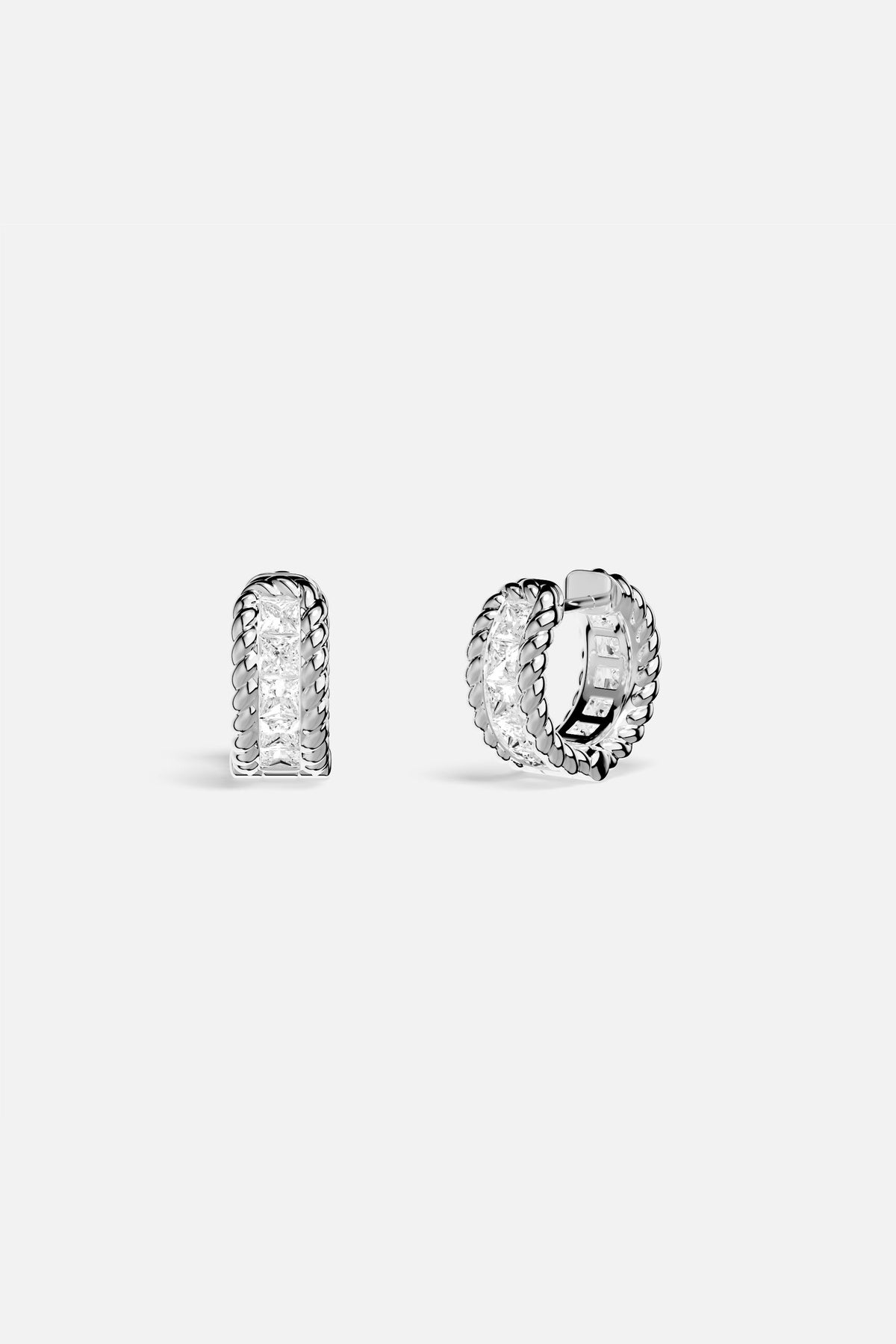 APM Hoop Earrings, twisted rhodium finish framing a luminous crystal path.