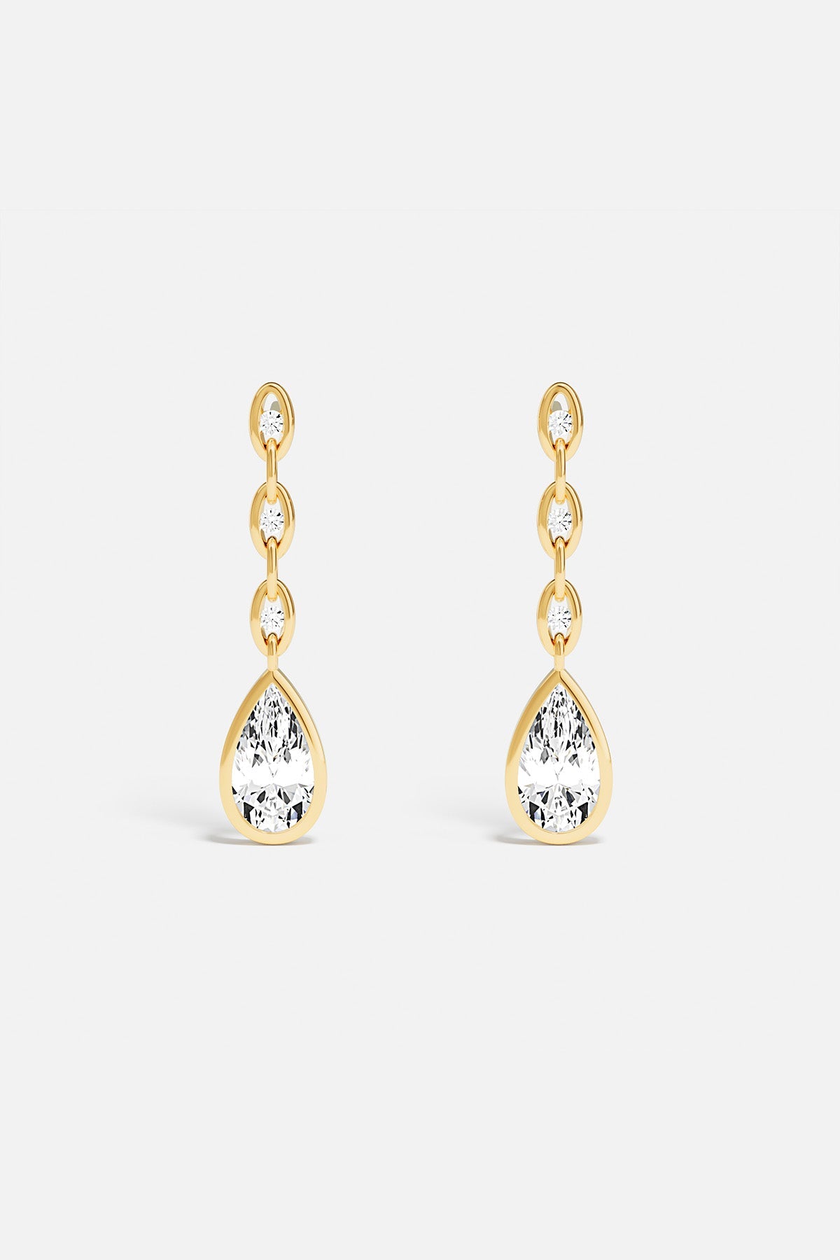 APM drop earrings, a golden cascade ending in luminous elegance.