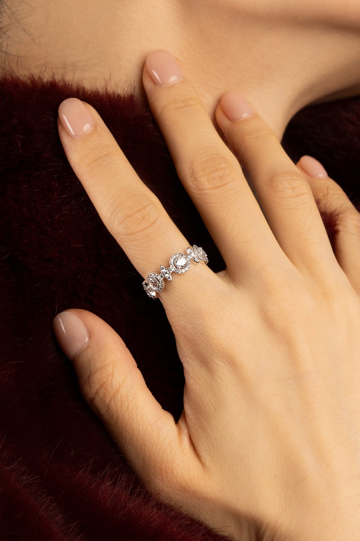 Woman wearing APM ring, a delicate sparkle of quiet winter elegance.