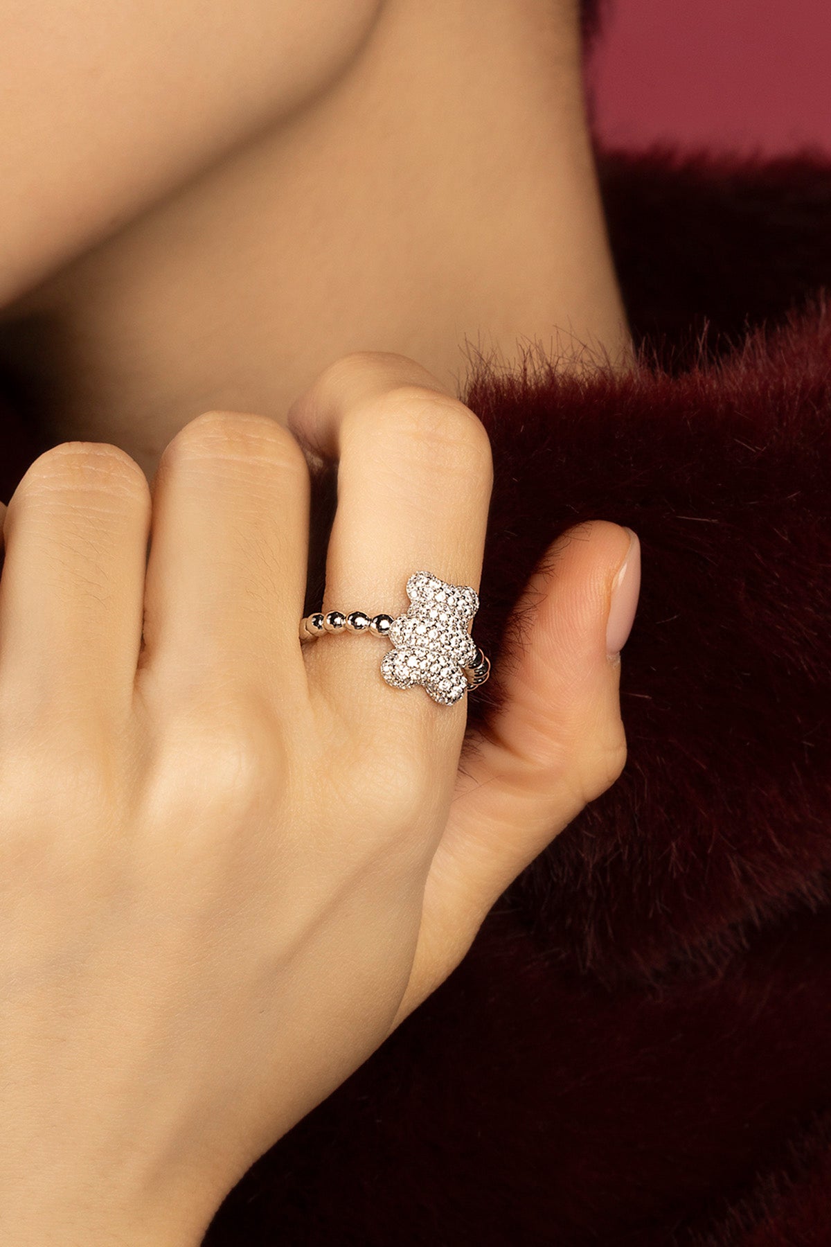 Woman wearing APM bear ring, playful sparkle meets soft everyday charm.
