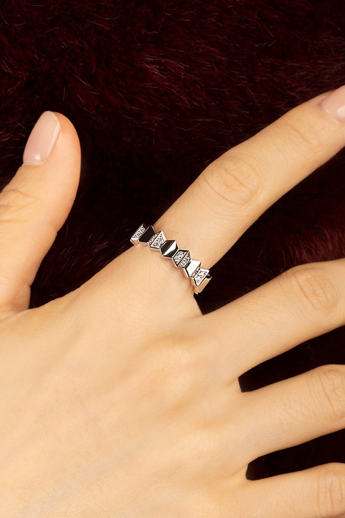 Woman wearing APM Morse Ring, geometric edge in rhodium finish, quiet elegance.