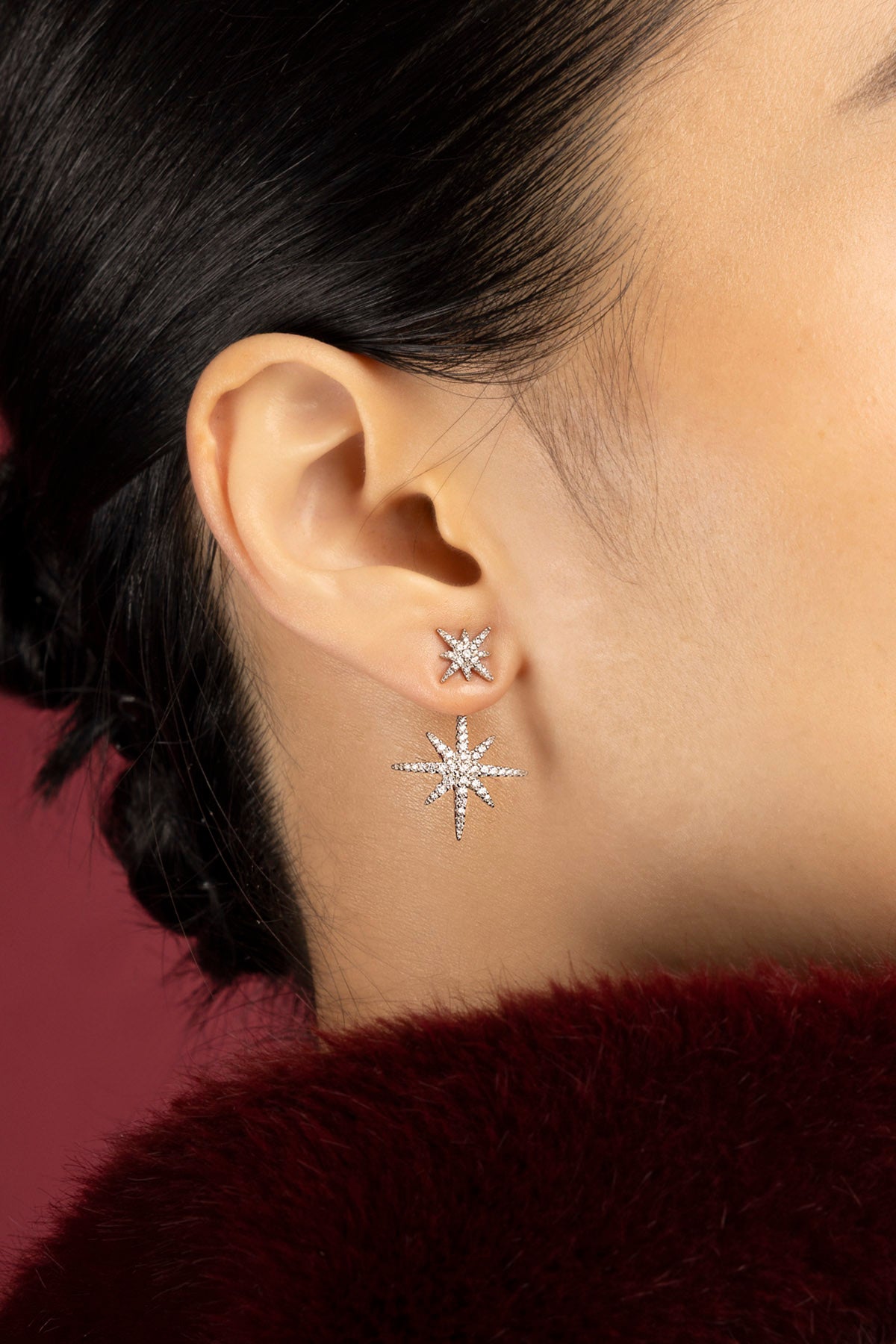 Woman wearing APM Météorites Earrings, a constellation of sparkle drifting close to skin.